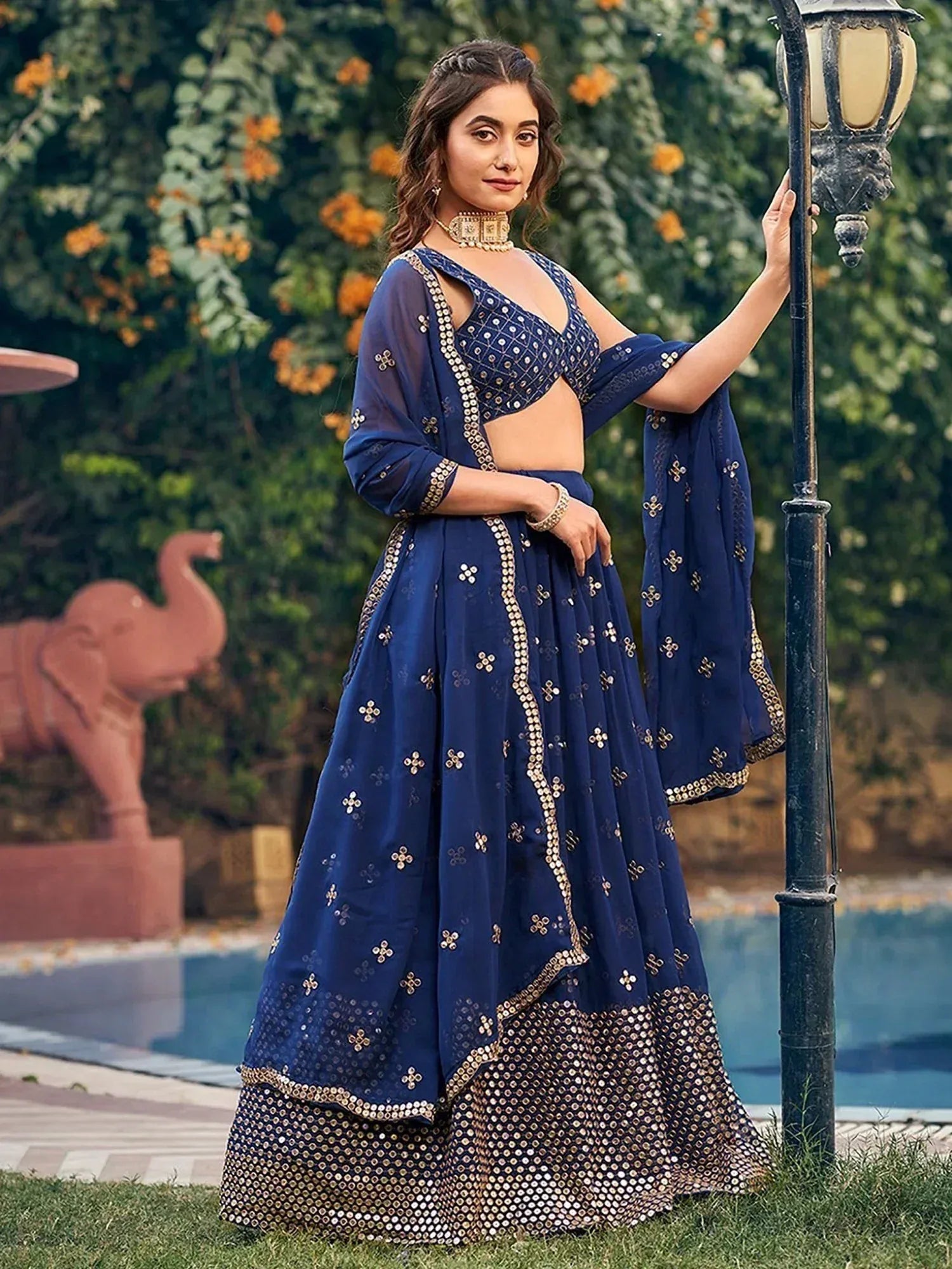 Navy blue designer lehenga choli with gold mirror work, perfect for Indian ethnic wear occasions