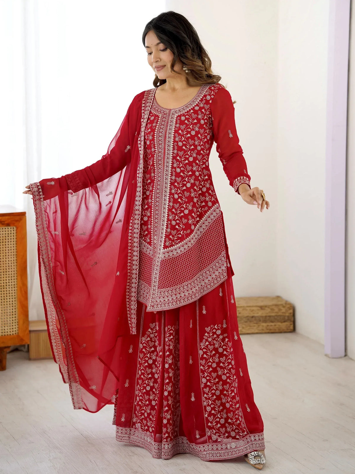Red embroidered salwar kameez with floral detailing and matching dupatta, ideal for Indian ethnic wear