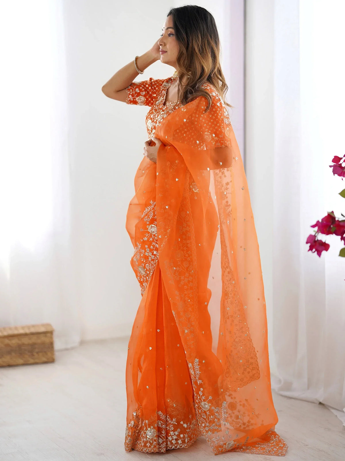 Orange embroidered saree with gold floral work, perfect for Indian ethnic wear occasions