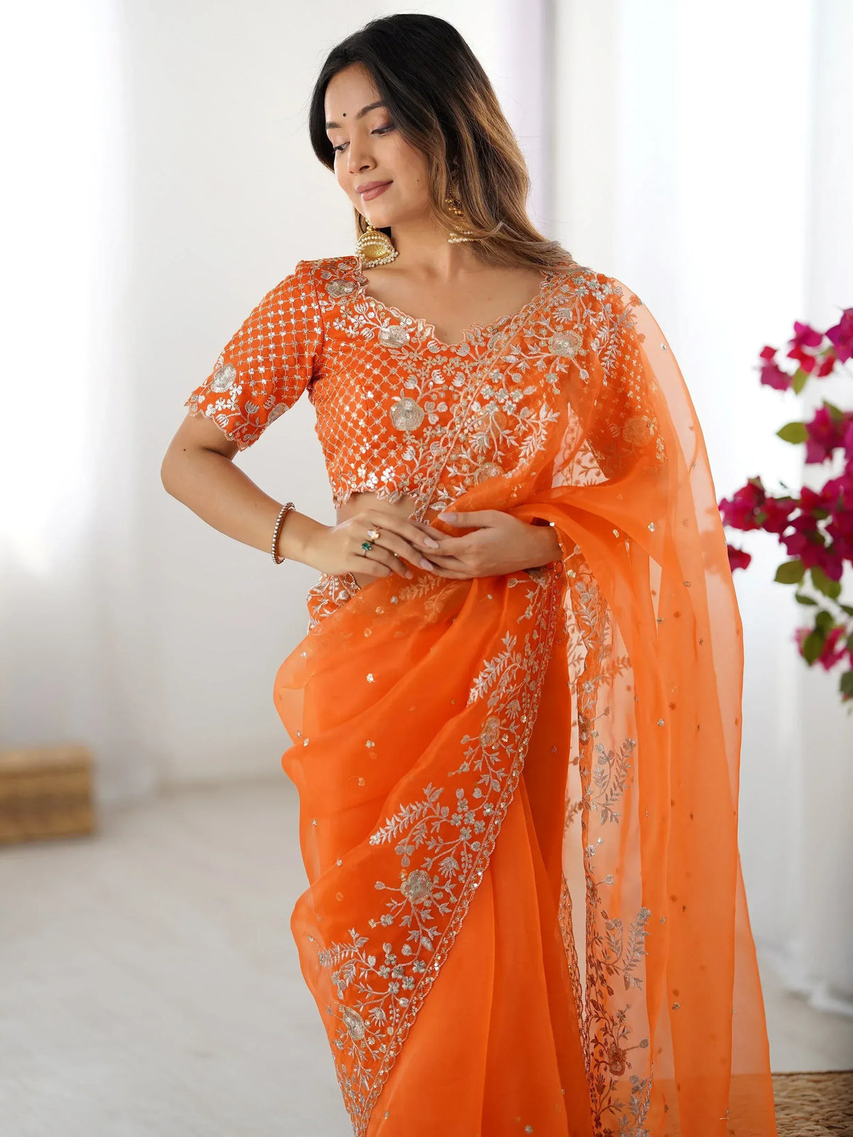 Orange embroidered saree with floral zari work, perfect for Indian ethnic wear occasions