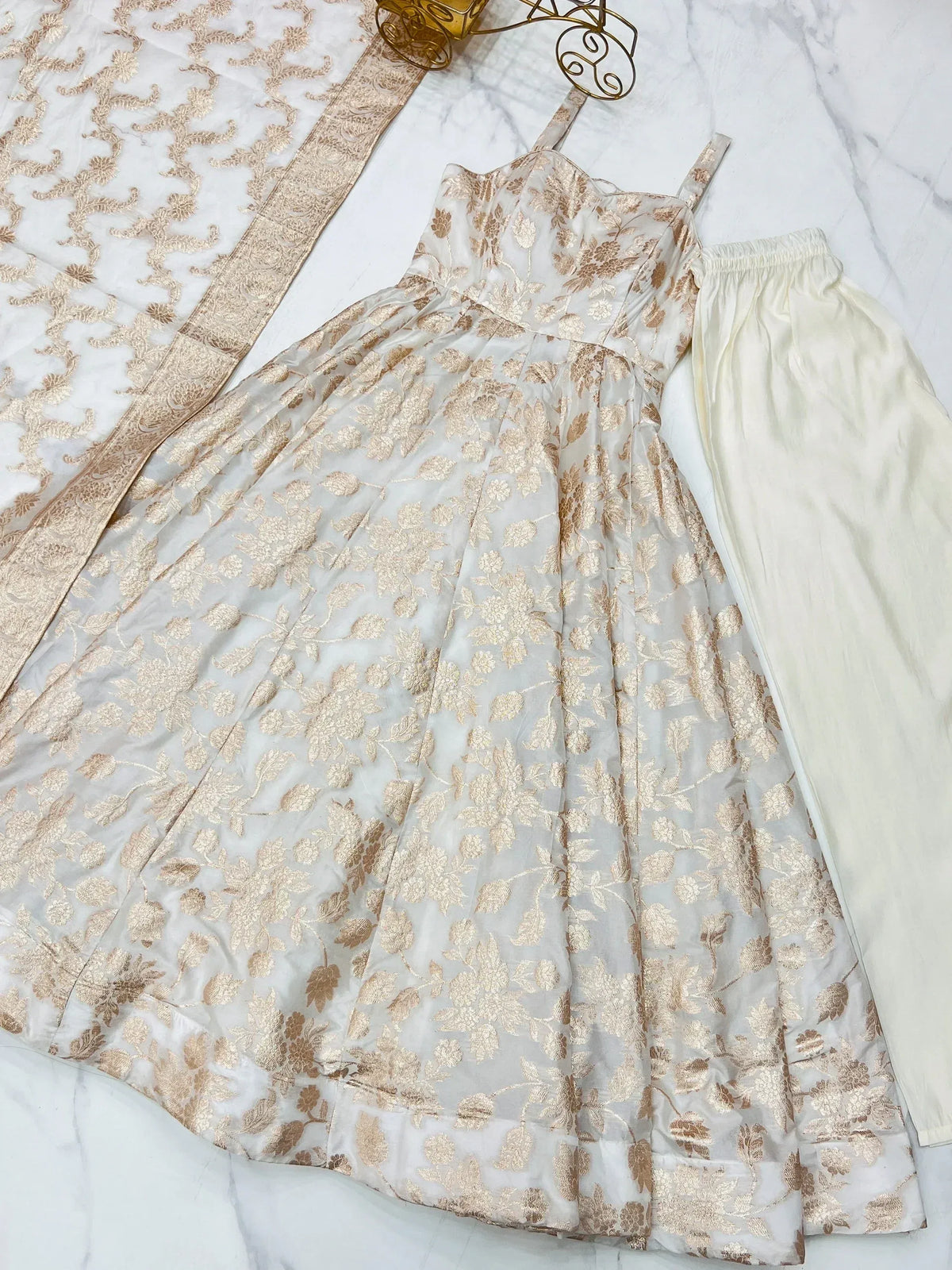 Elegant white and gold floral print ethnic gown with matching palazzo pants and dupatta, perfect for Indian occasions.