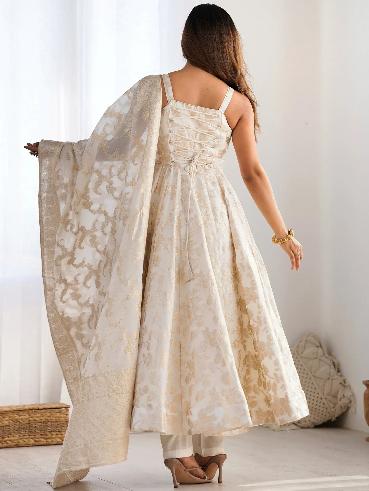 Cream and gold floral print ethnic gown with lace-up back and matching dupatta, perfect for Indian occasions.