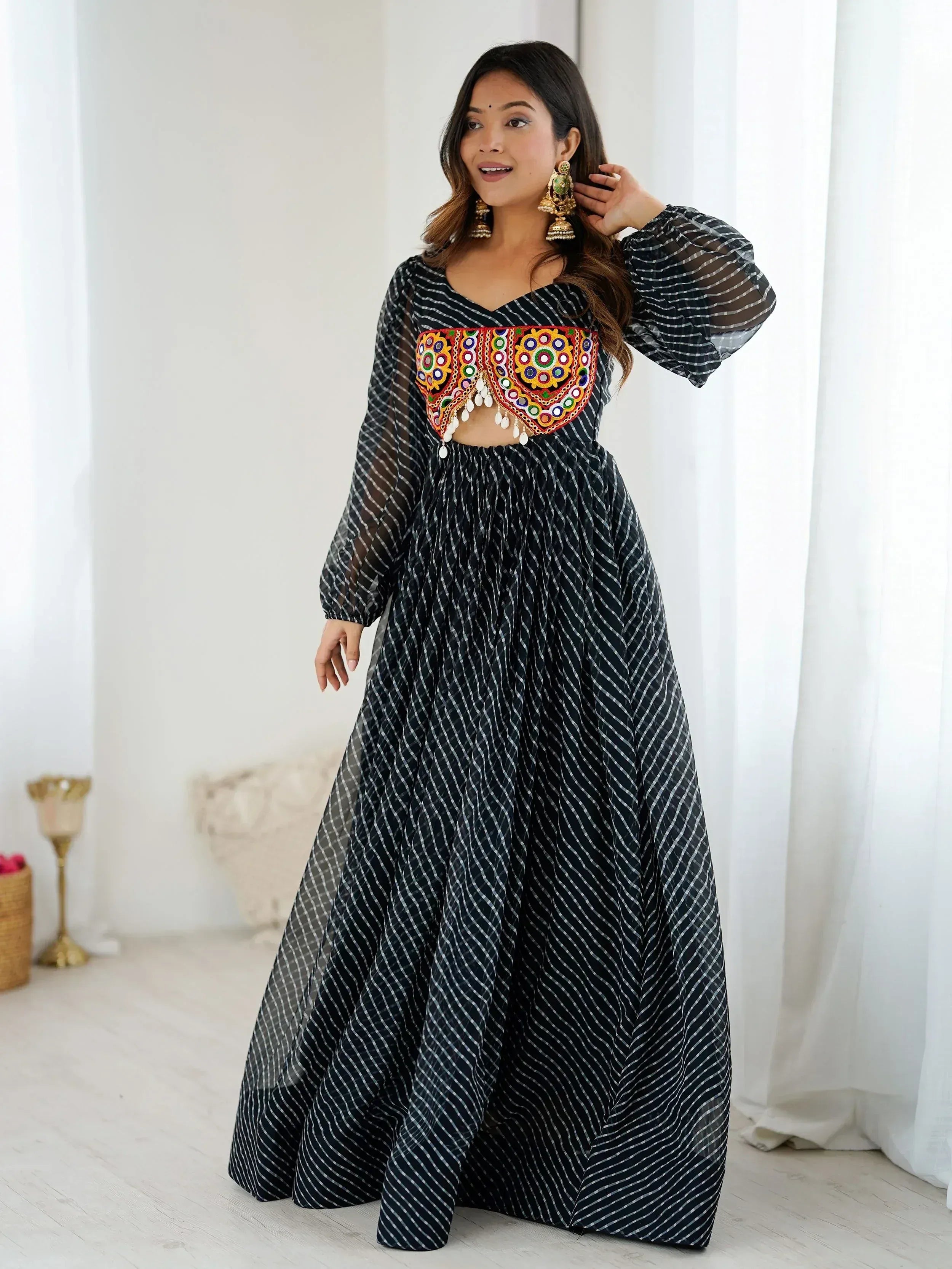 Black and white striped ethnic gown with colorful mirror work bodice, perfect for Indian occasions