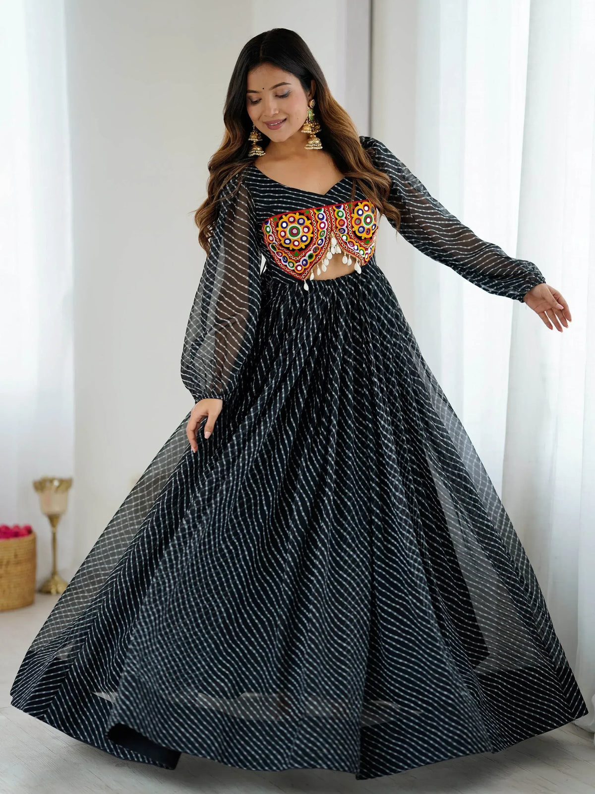 Black and white striped ethnic gown with colorful mirror work blouse, perfect for Indian occasions