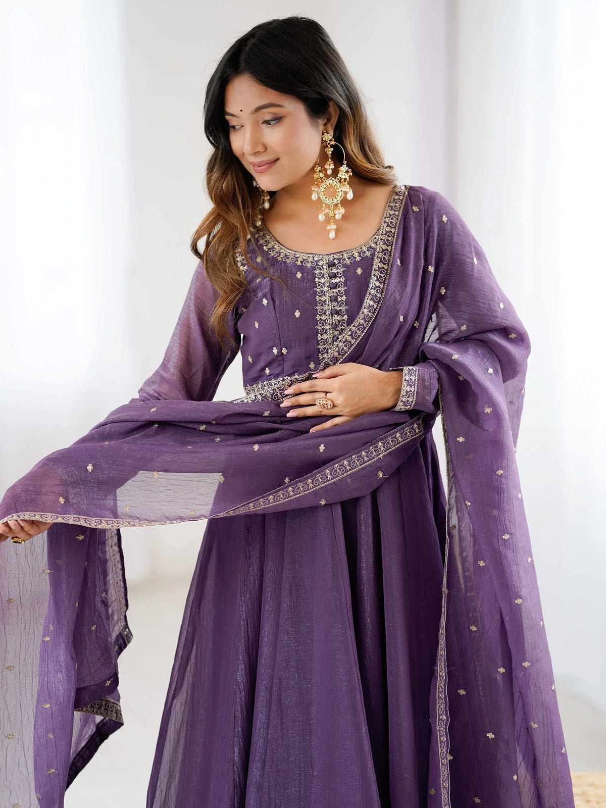 Purple embroidered ethnic gown with gold detailing and matching dupatta