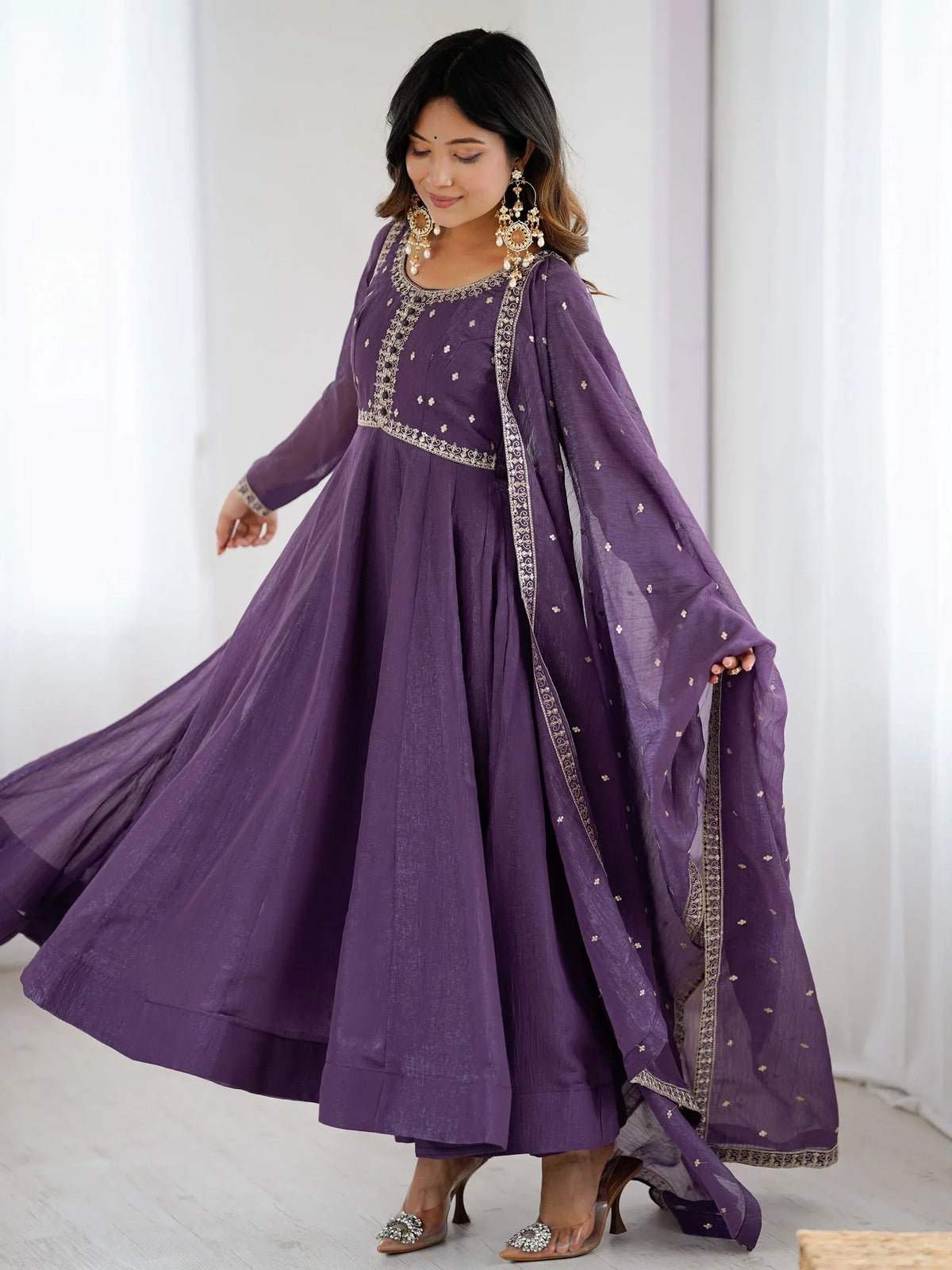 Purple ethnic anarkali gown with gold embroidery and matching dupatta, perfect for festive occasions.