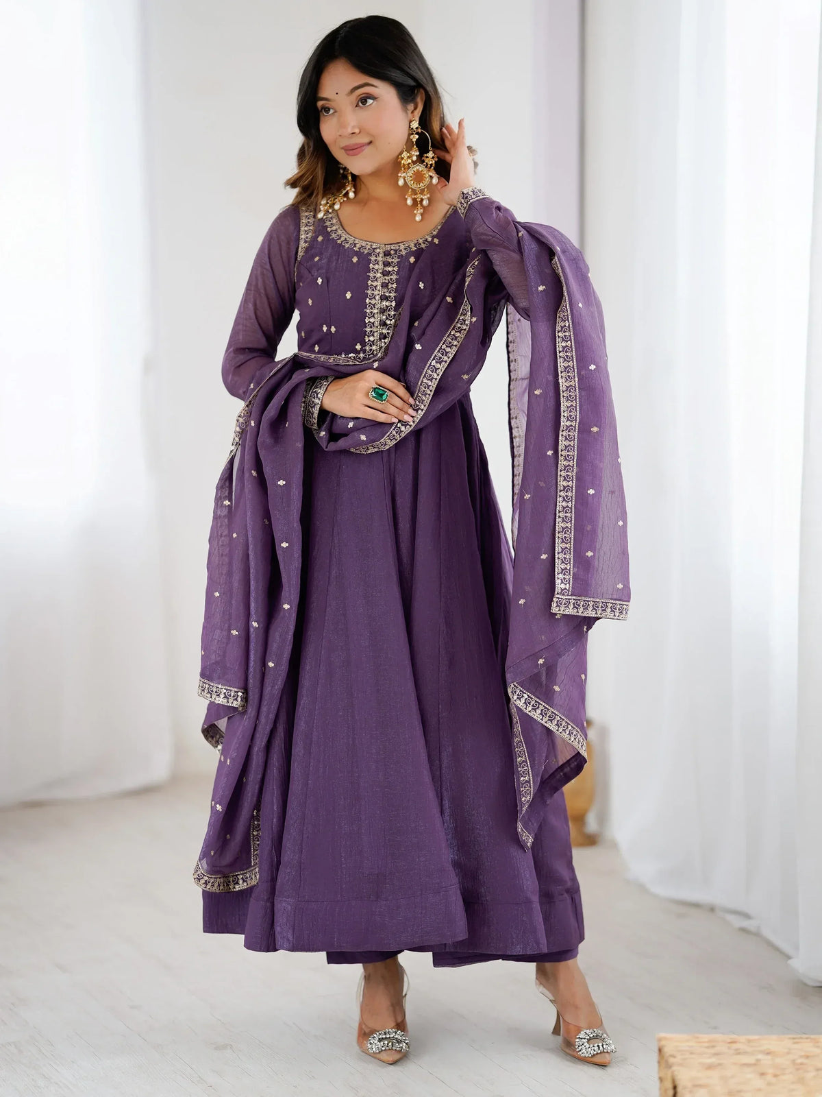 Purple ethnic anarkali suit with gold embroidery and matching dupatta, perfect for festive occasions.