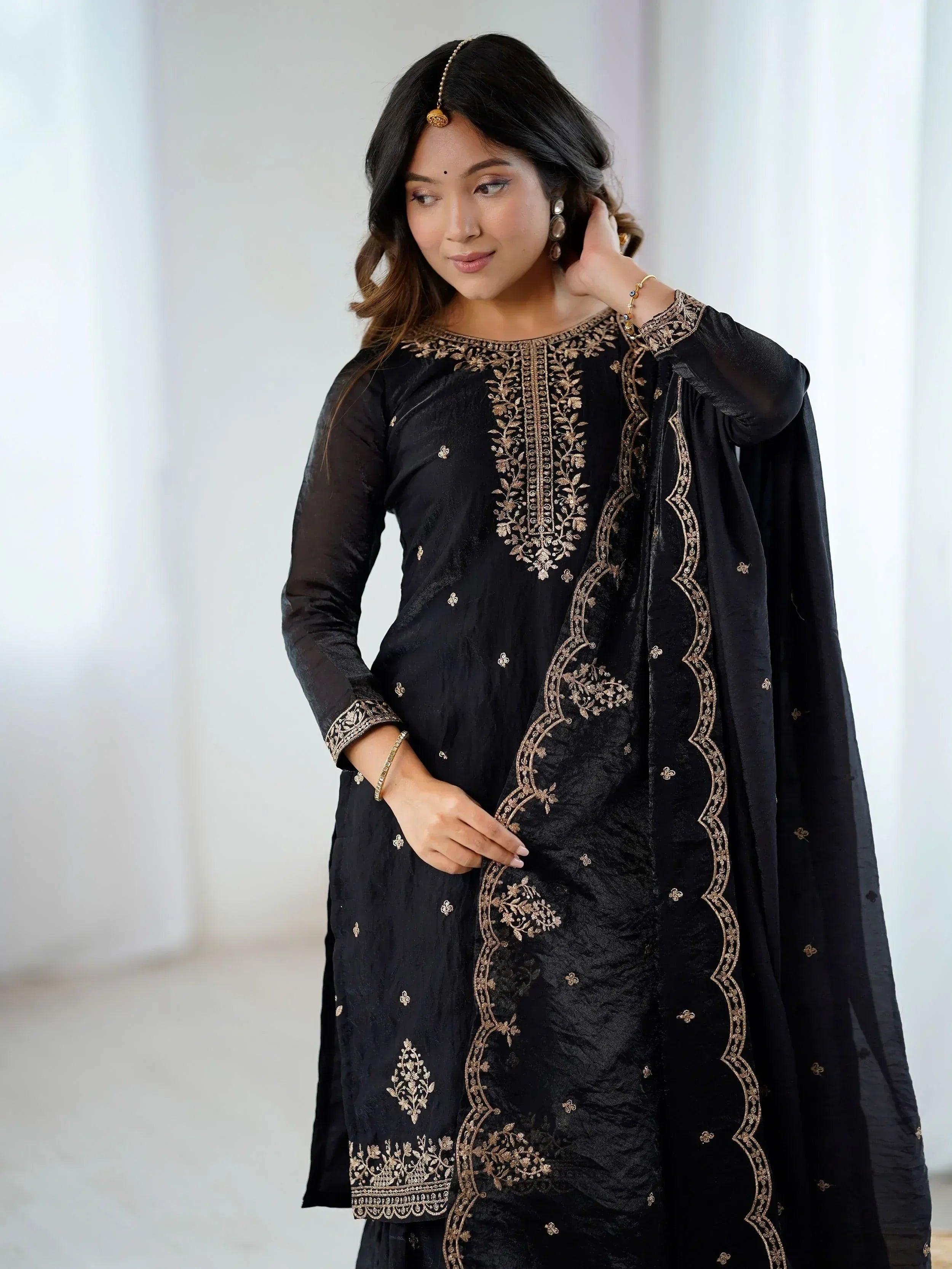 Black ethnic salwar kameez with gold embroidery, perfect for Indian festive wear