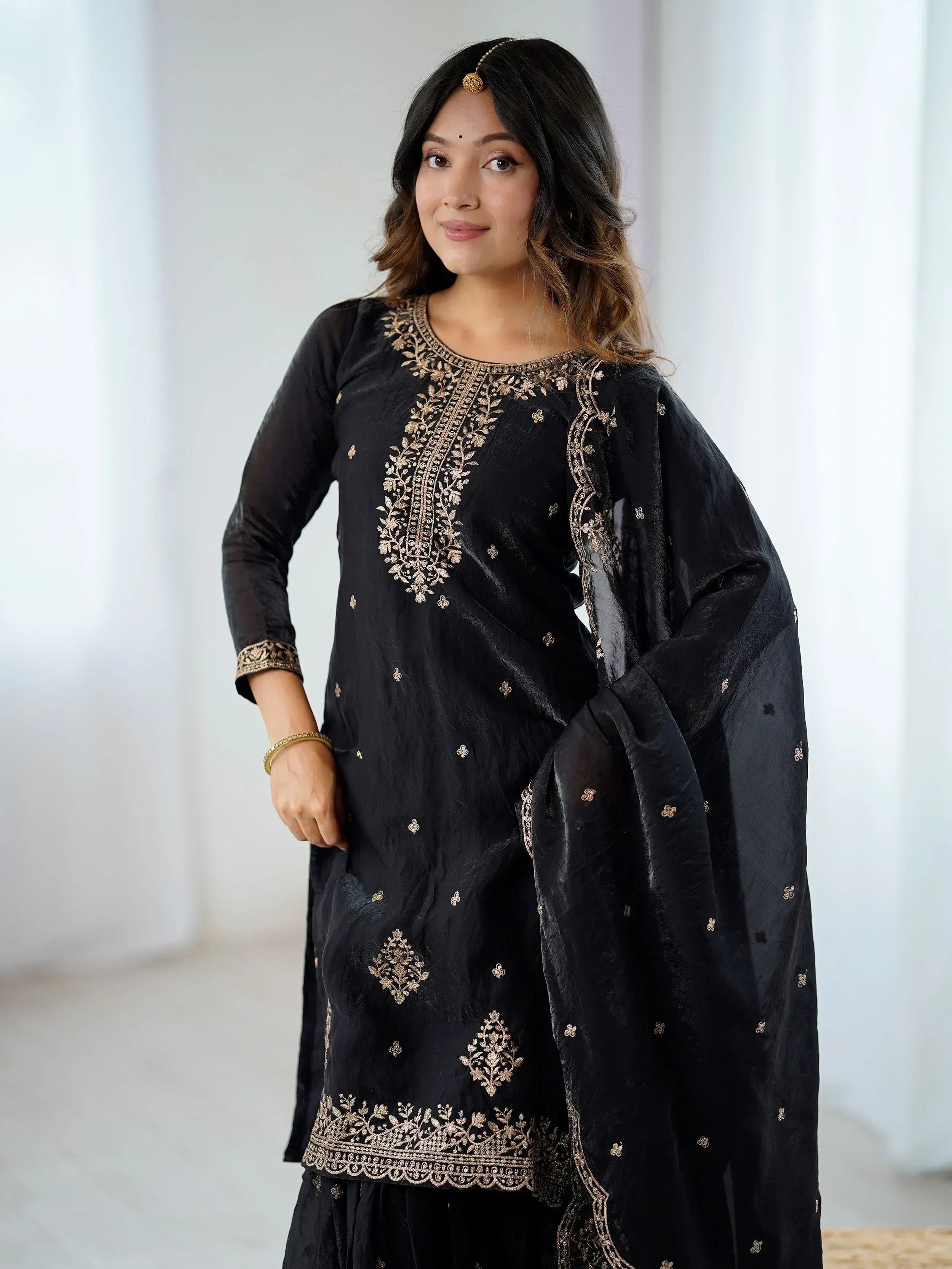 Black embroidered salwar kameez with gold detailing, perfect for Indian ethnic wear occasions