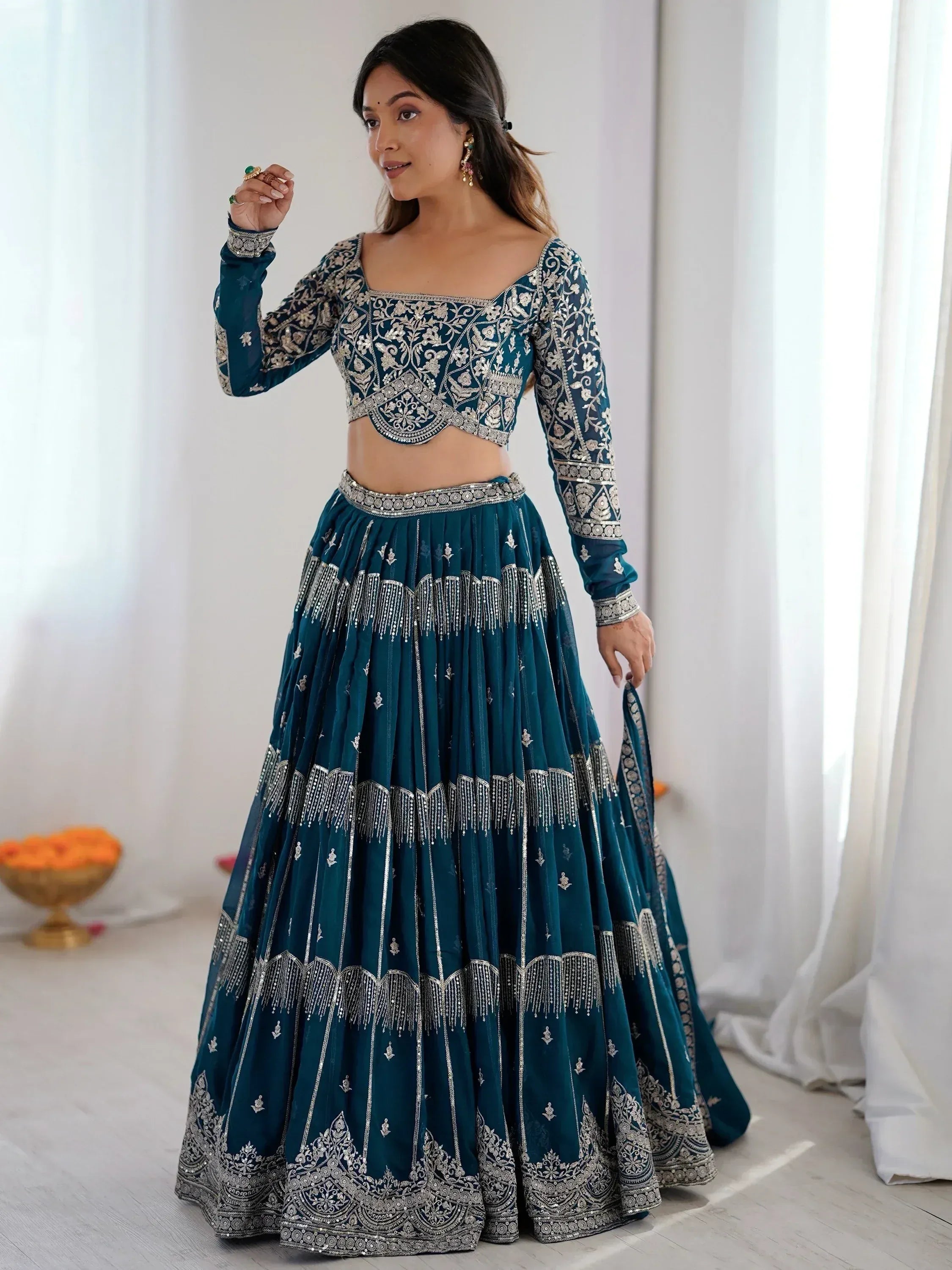 Teal designer lehenga choli with silver embroidery, perfect for weddings and festivals.