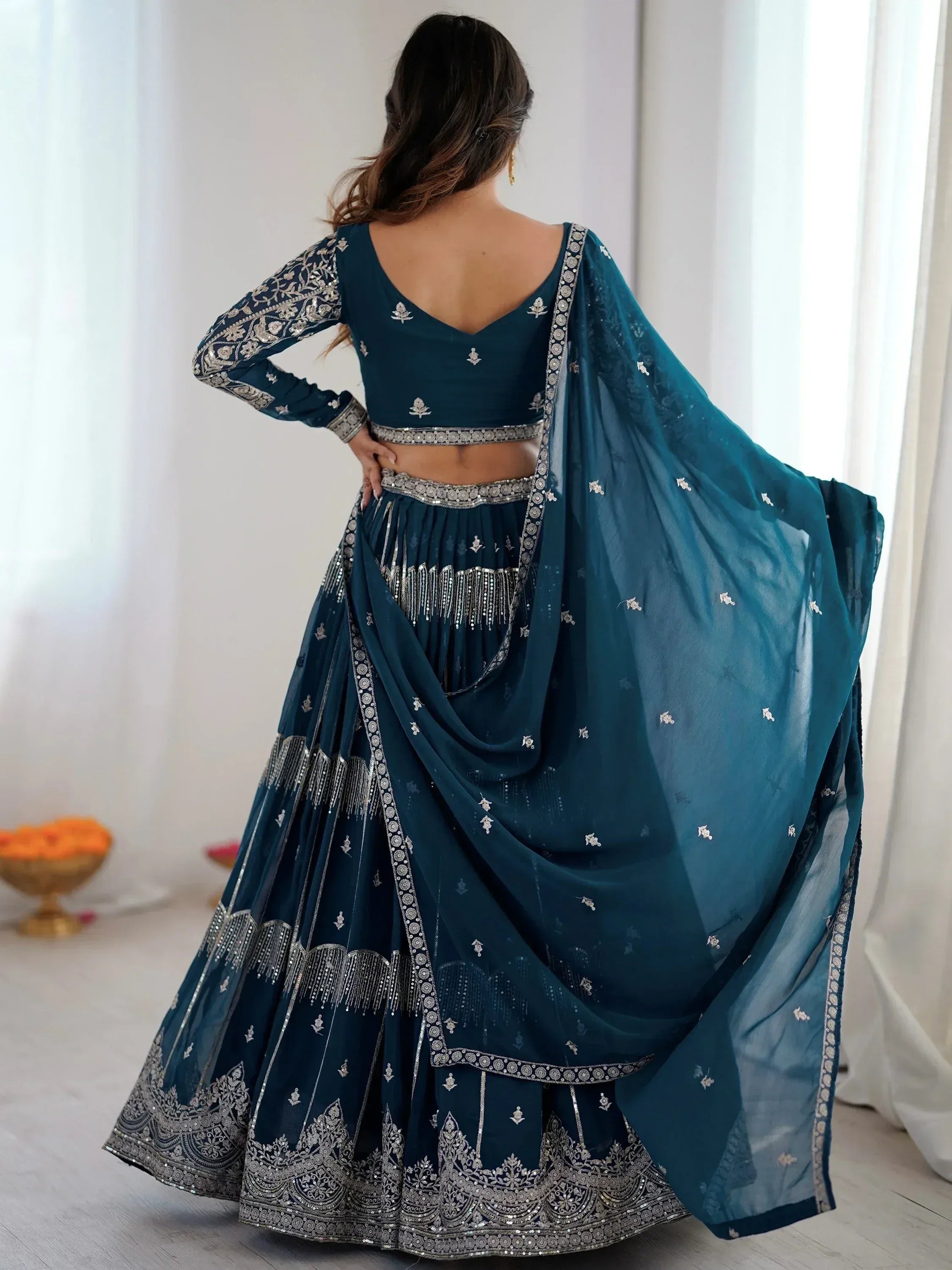 Teal blue designer lehenga choli with silver embroidery and dupatta, ethnic Indian wear for weddings