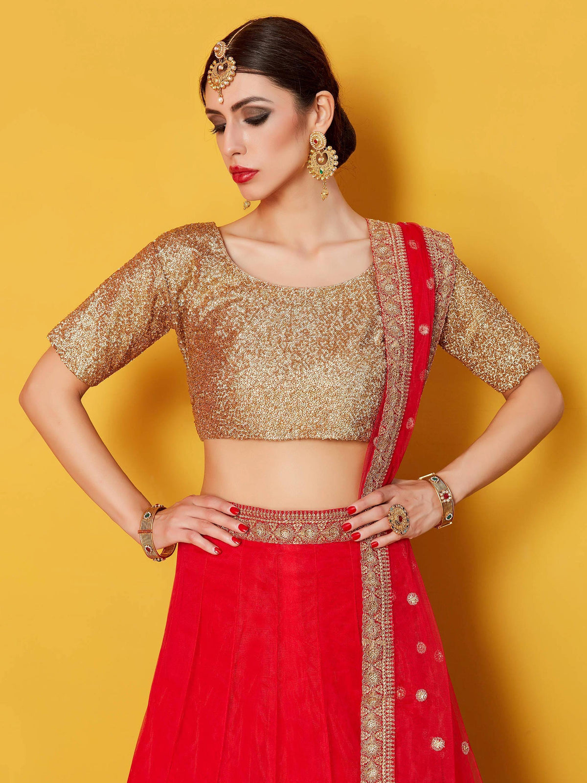 Red and gold designer lehenga choli with sequin blouse and ethnic jewelry for Indian weddings