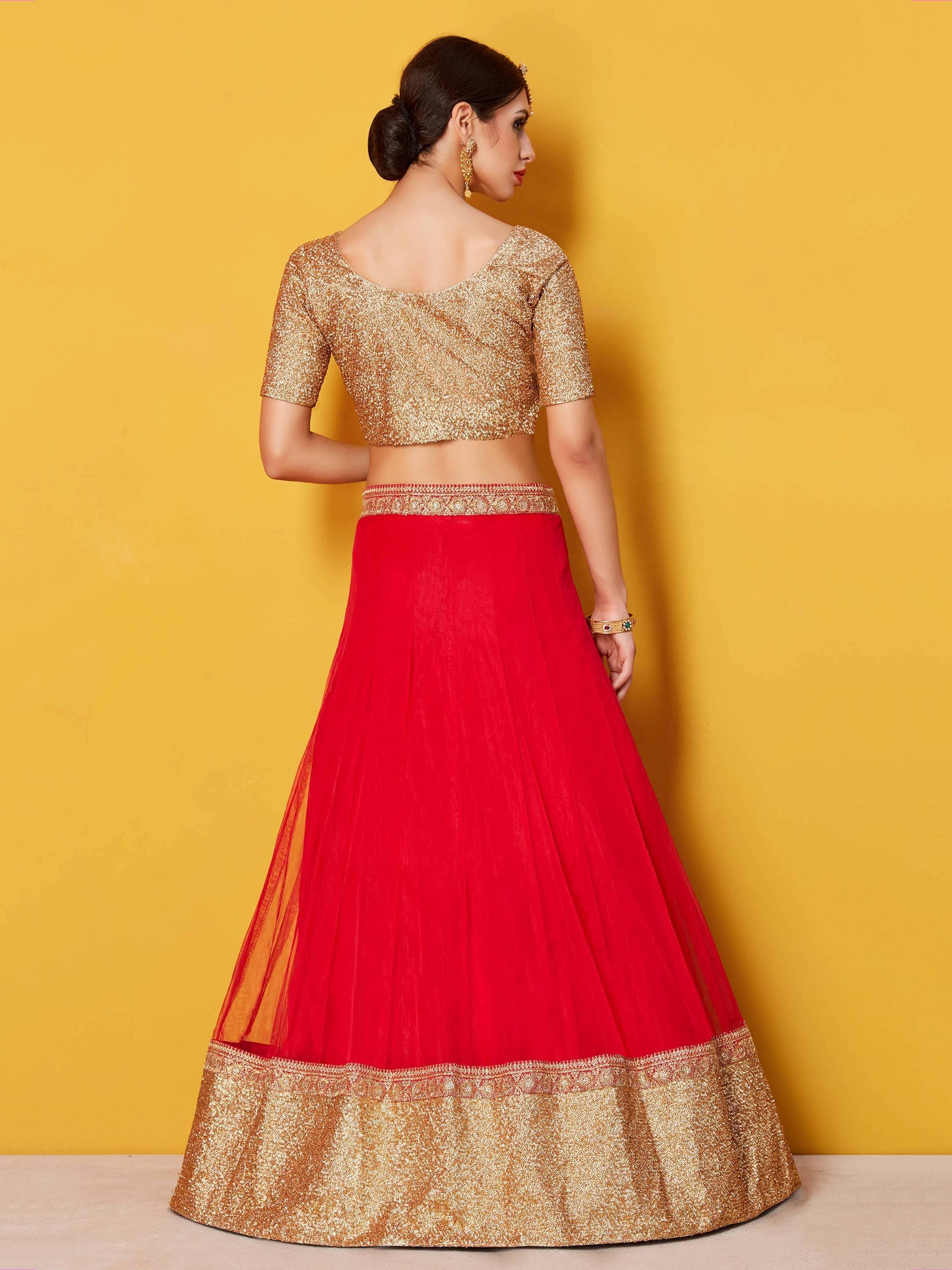 Red and gold lehenga choli with glitter top and embroidered skirt, perfect for Indian weddings and festivals