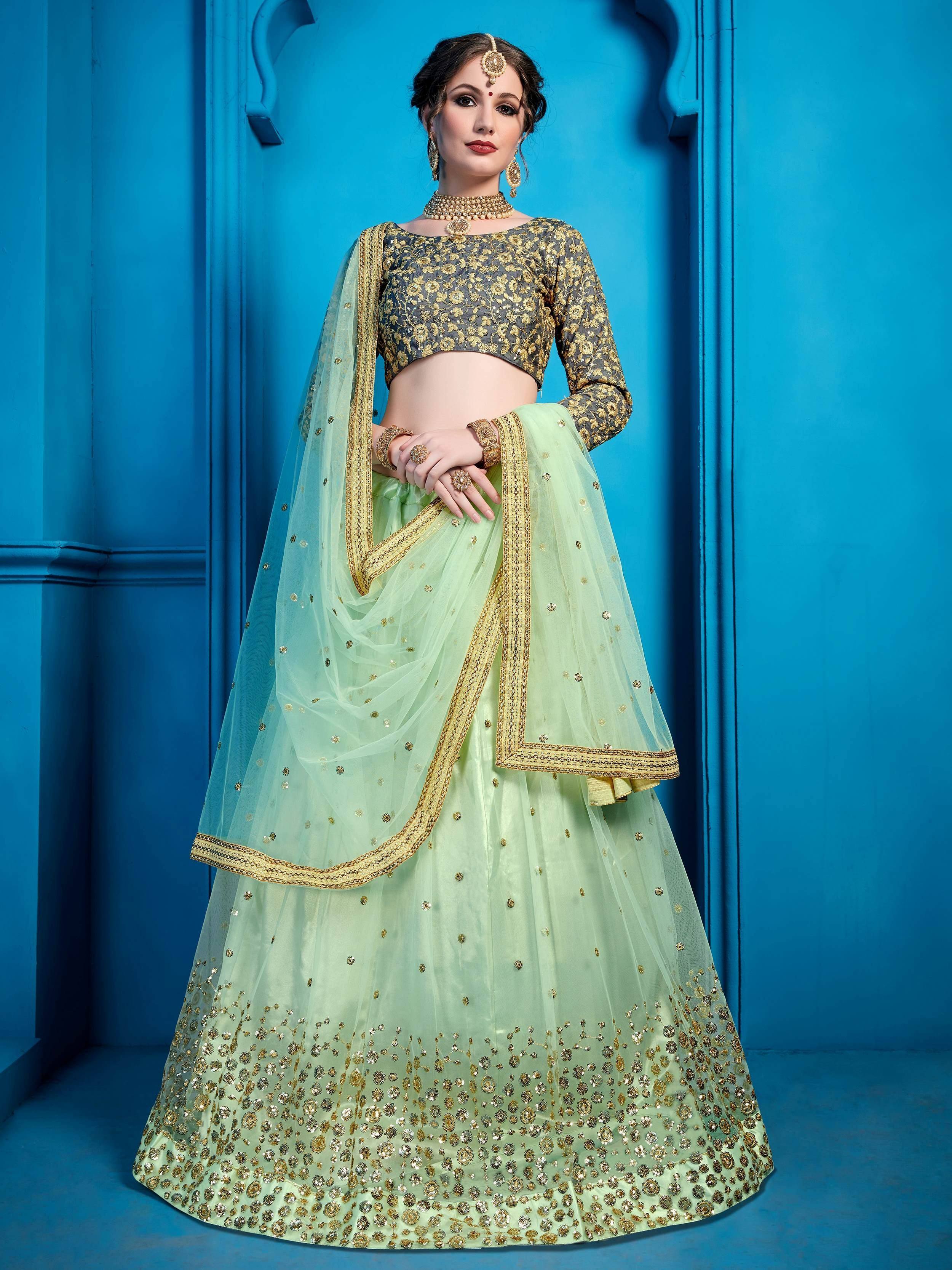 Mint green lehenga choli with gold embroidery, perfect for Indian weddings and festive occasions.