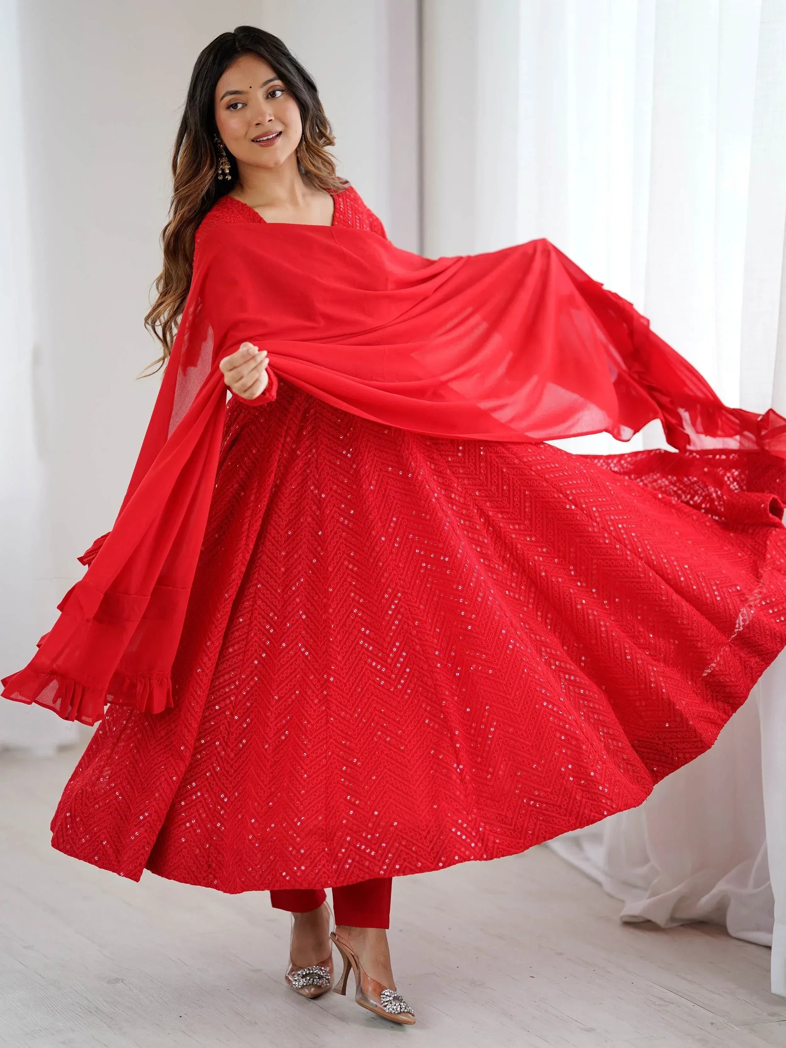 Red sequin ethnic gown with flowing dupatta, perfect for festive occasions