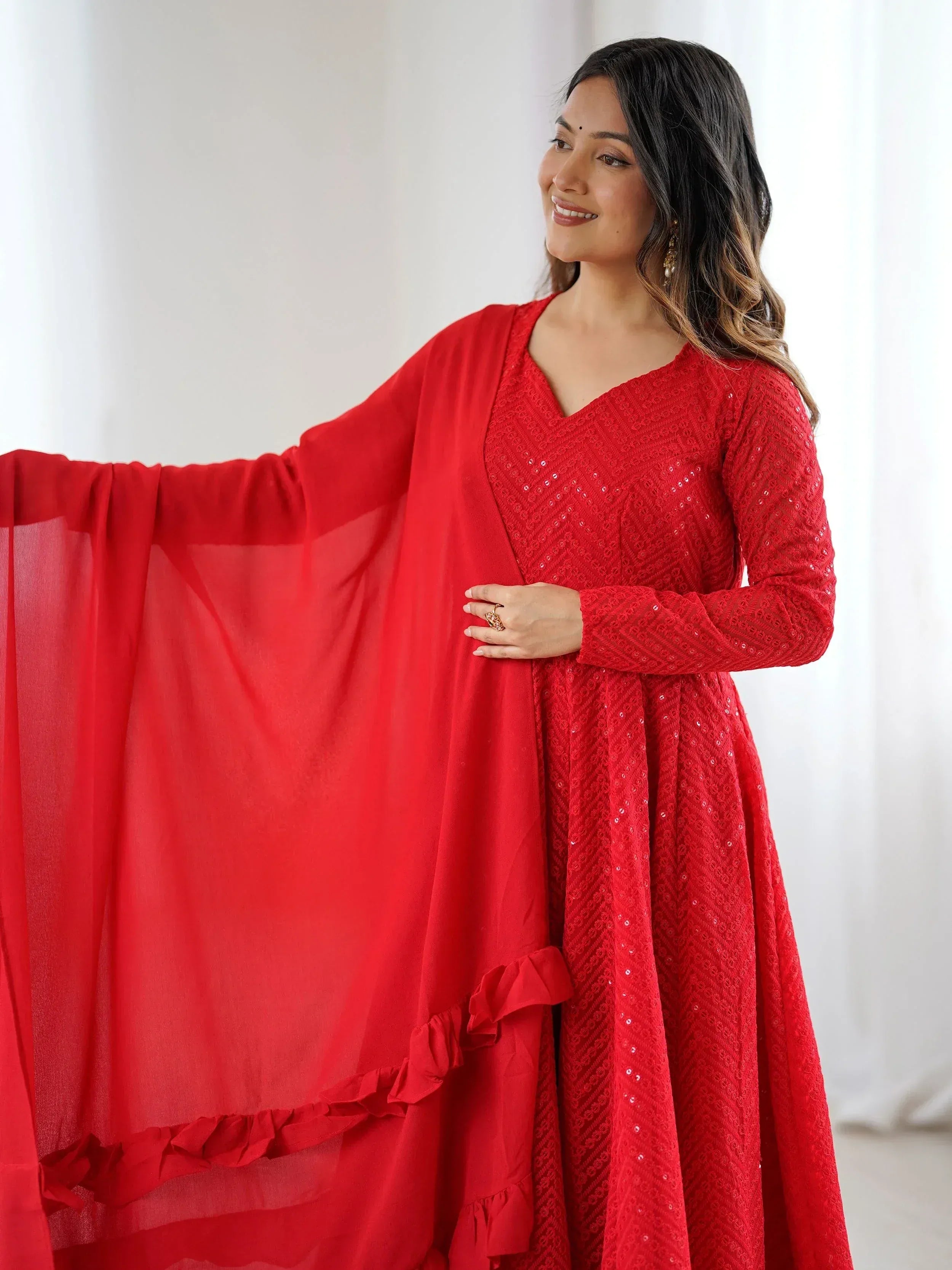 Red ethnic gown with sequin detailing and ruffled dupatta, perfect for Indian festive occasions