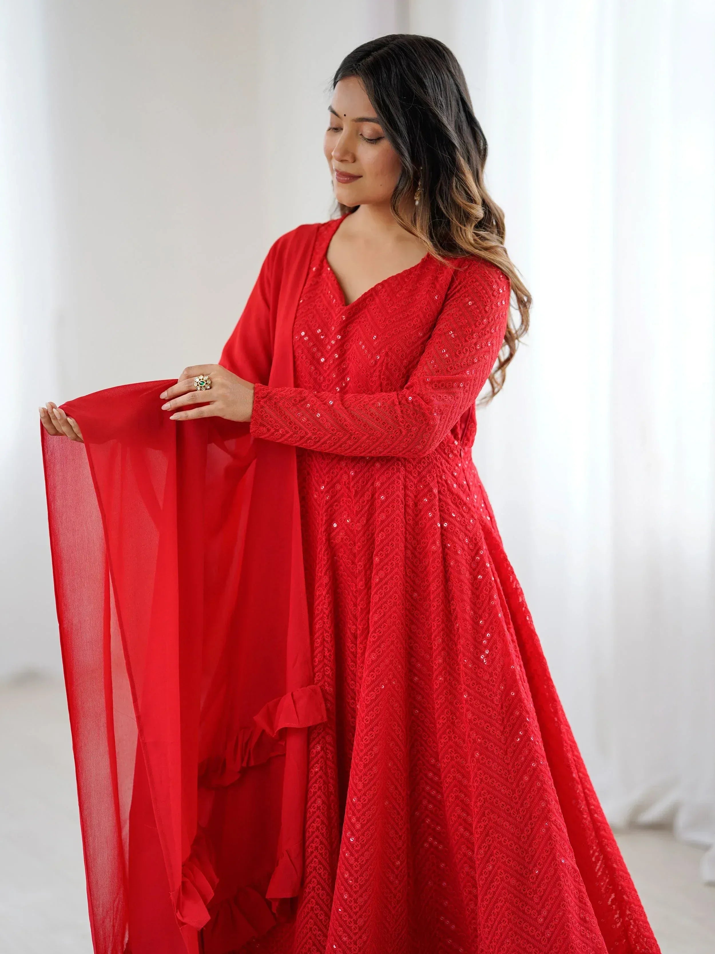 Red ethnic gown with sequins and sheer dupatta, perfect for Indian festive occasions