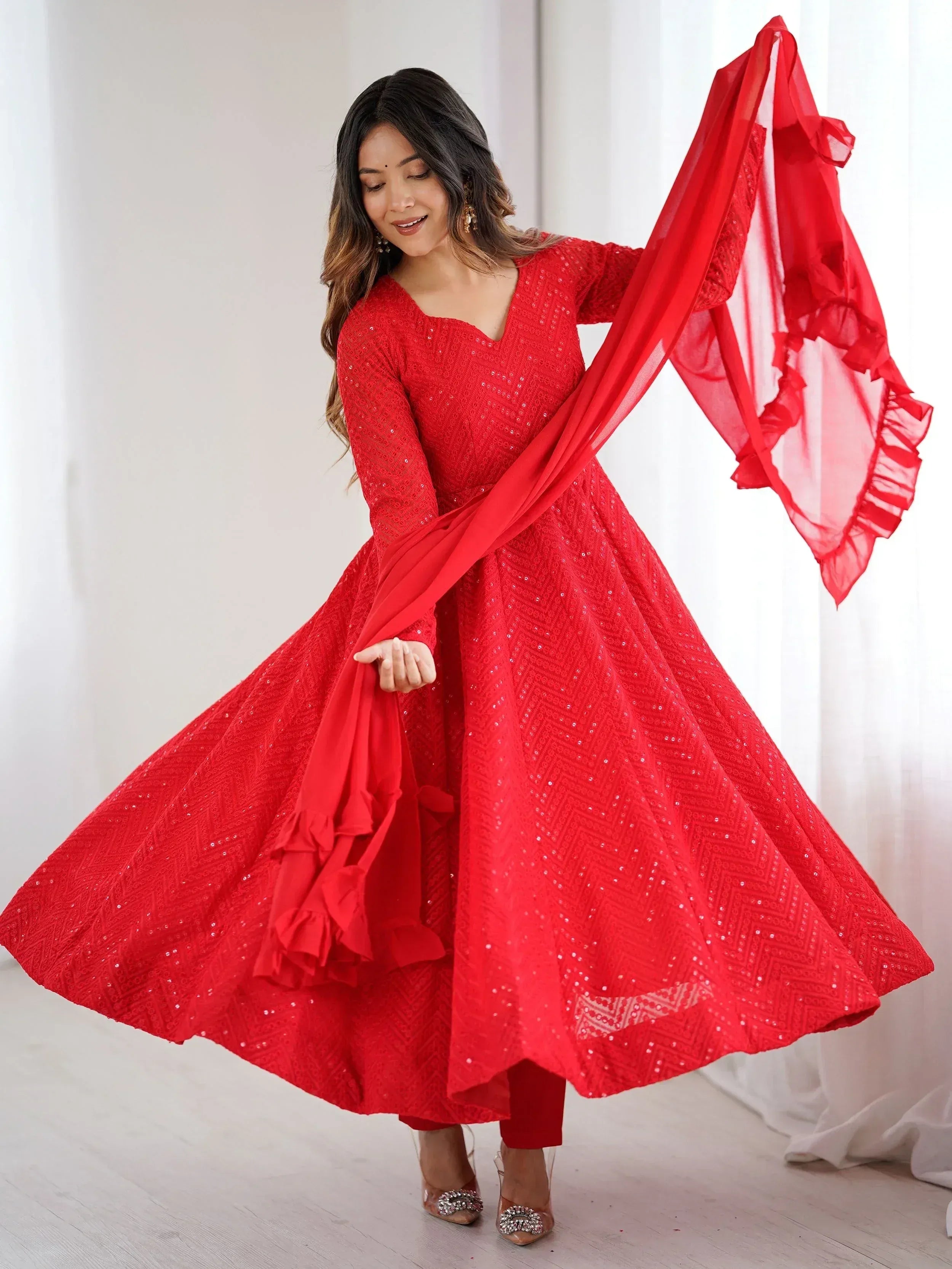 Red sequined ethnic gown with ruffled dupatta for festive occasions