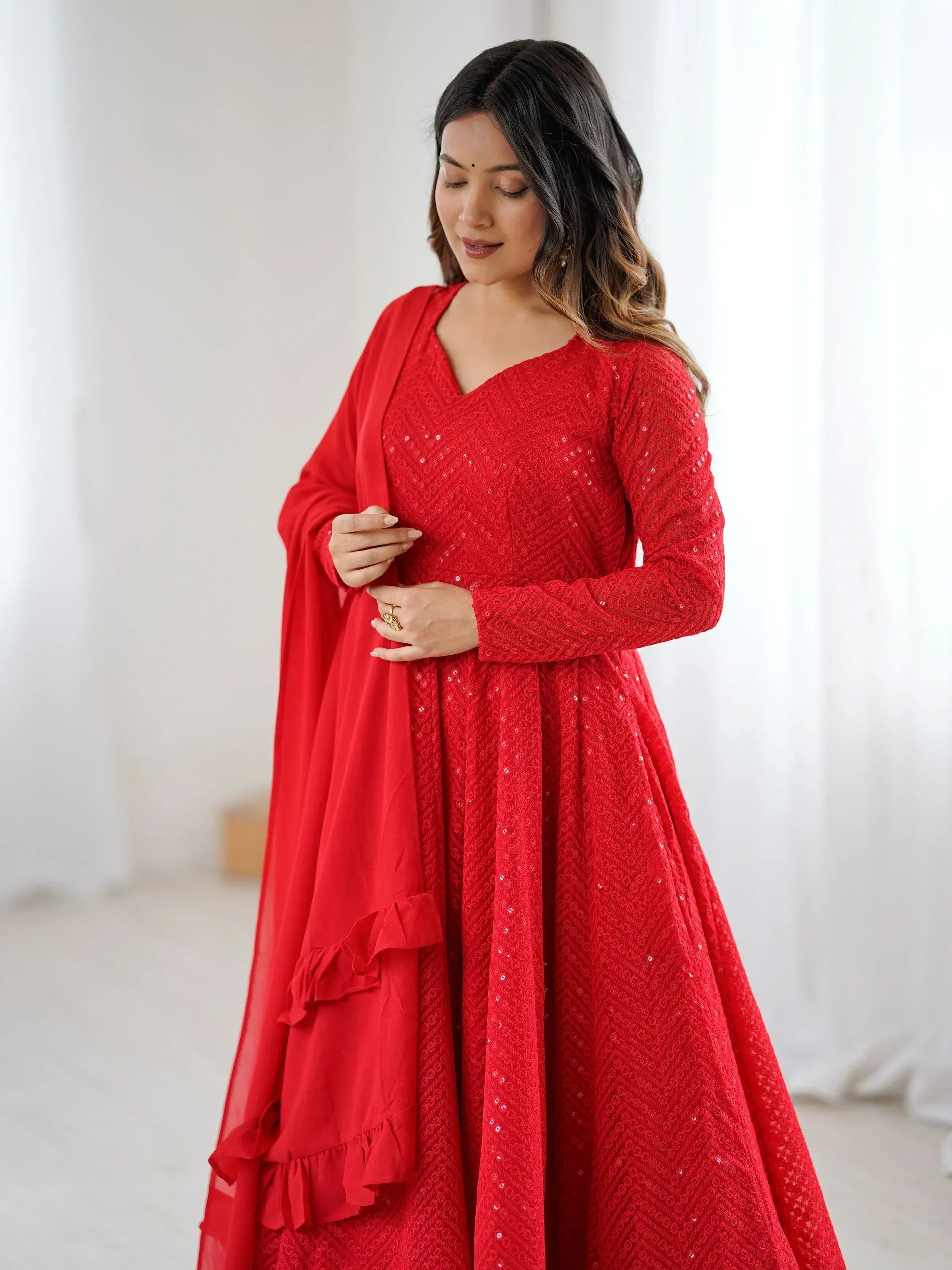 Red sequined ethnic gown with ruffled dupatta, perfect for Indian festive occasions