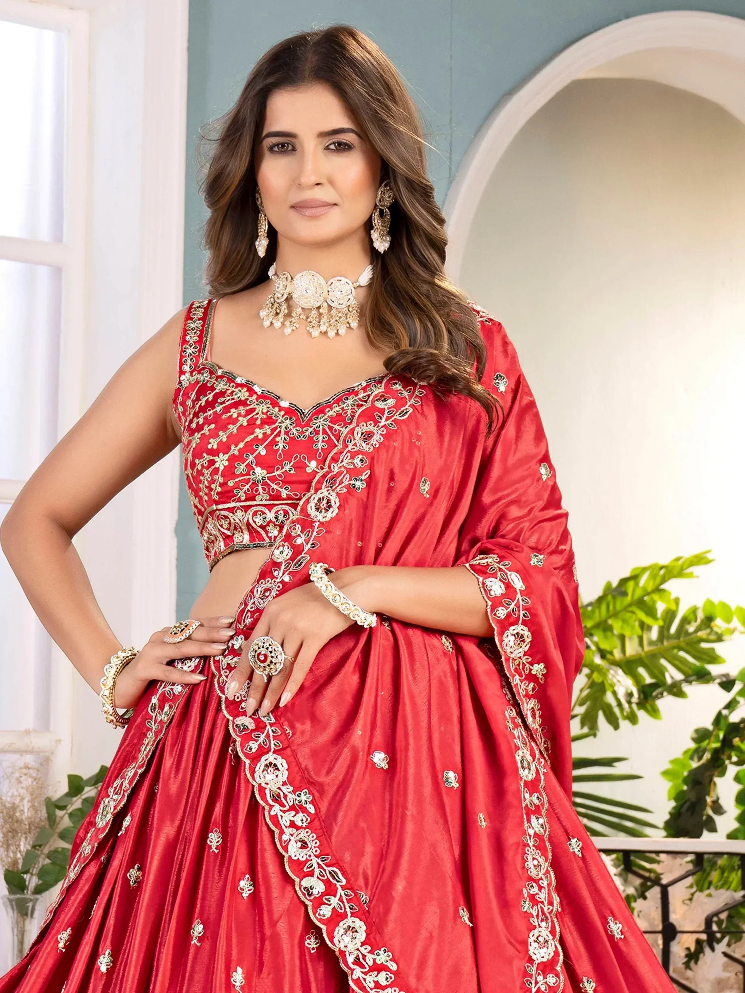 Red embroidered lehenga choli with gold floral detailing, perfect for Indian weddings and festive occasions.