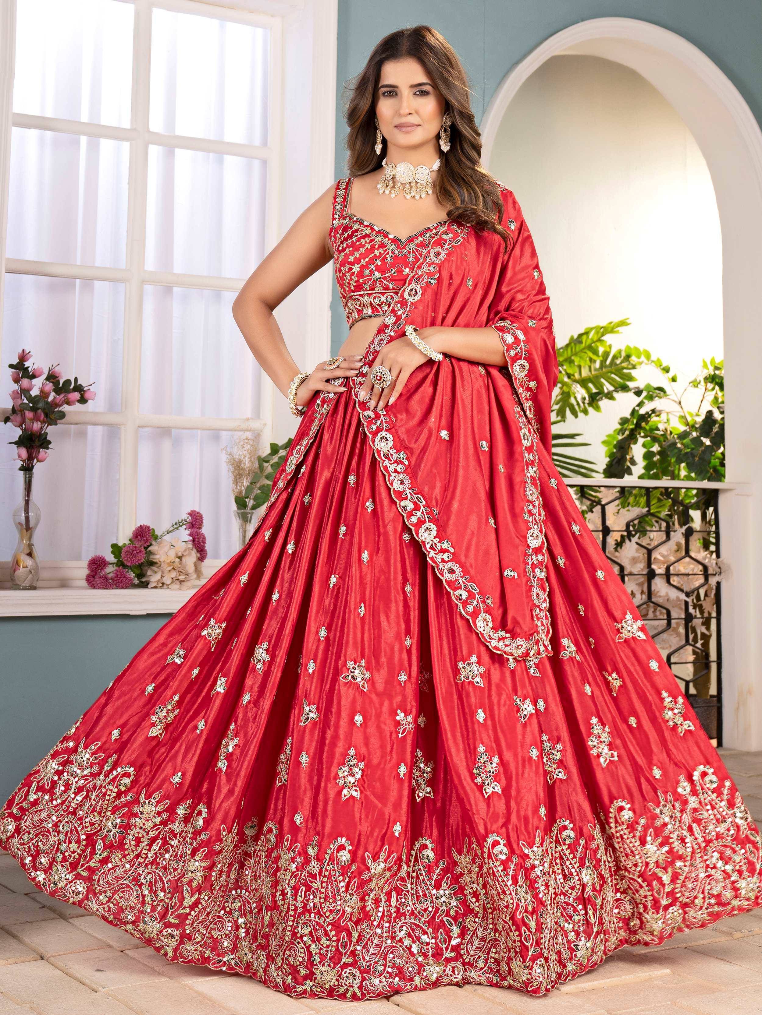 Red embroidered lehenga choli with gold detailing, perfect for Indian weddings and festive occasions