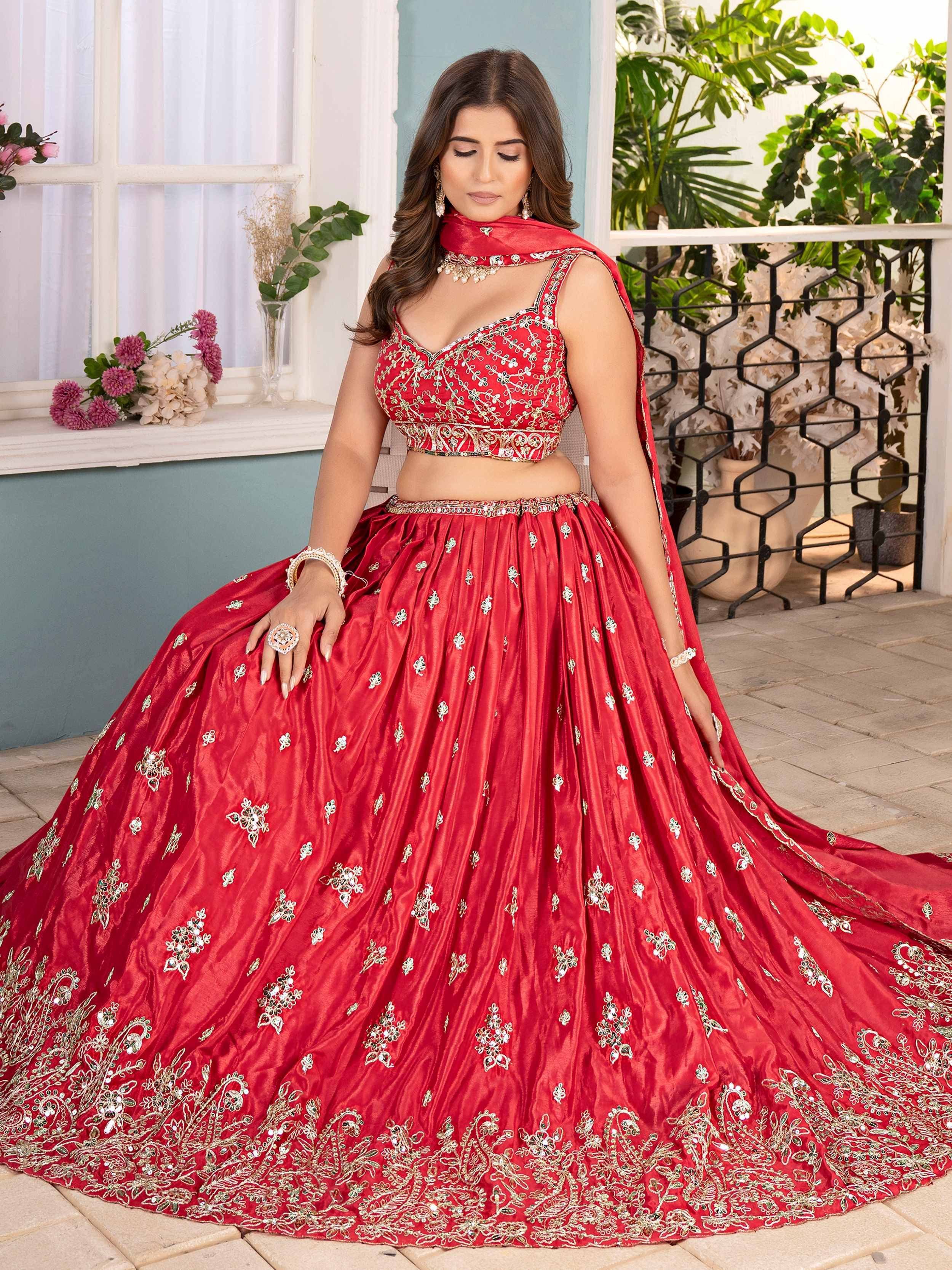 Red embroidered lehenga choli with gold detailing, perfect for Indian weddings and festive occasions.