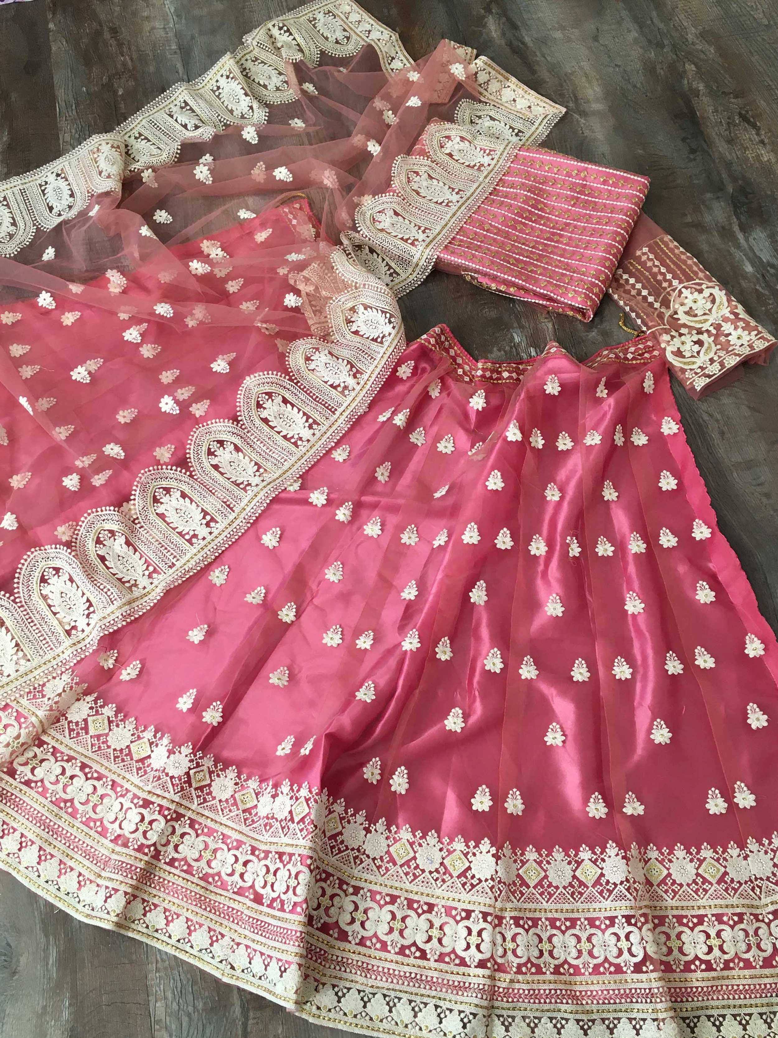 Pink embroidered lehenga choli with floral motifs and lace border, Indian ethnic wear