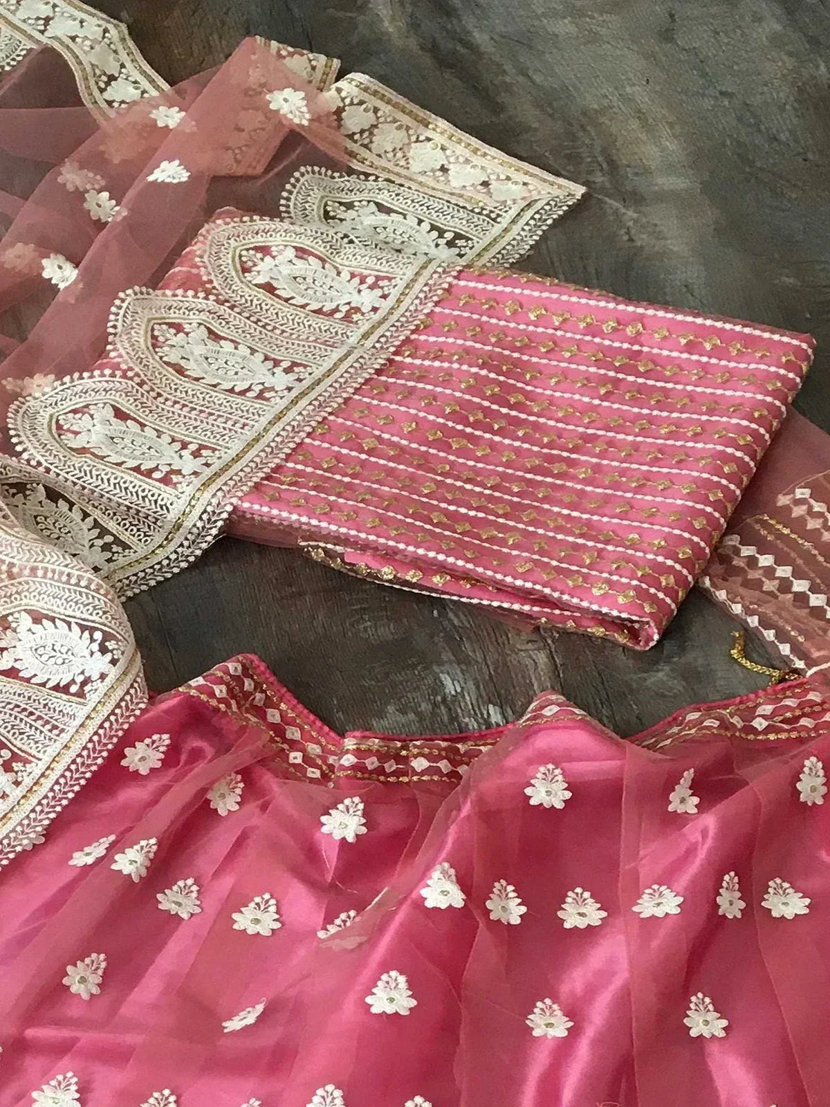 Pink designer lehenga choli with white floral embroidery and gold detailing, ethnic wear for women