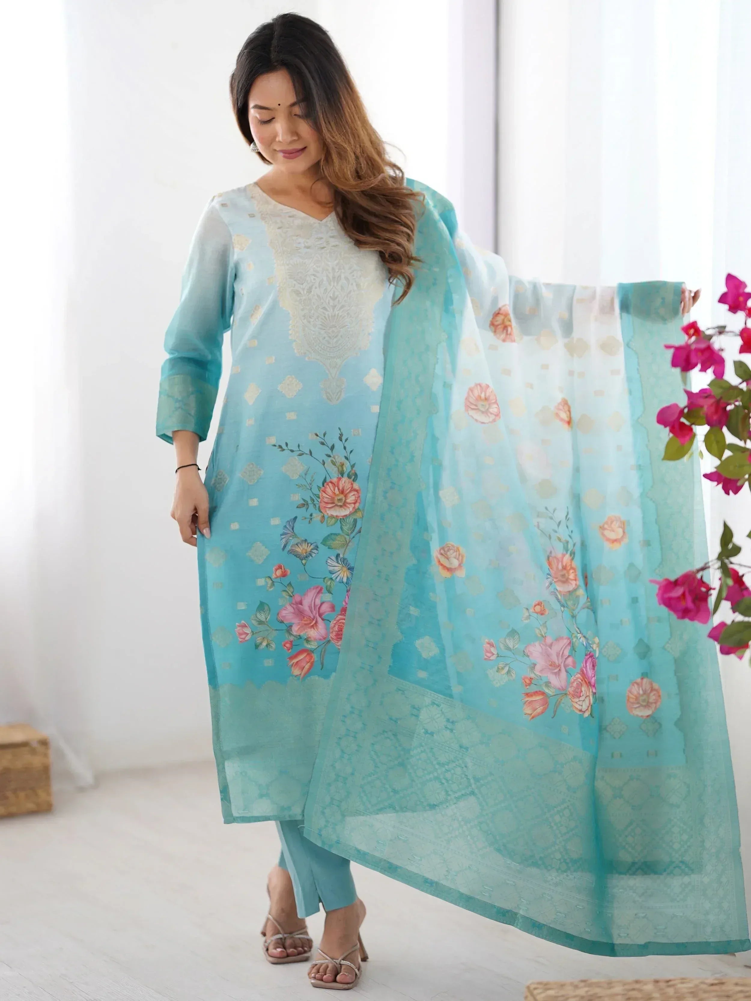 Light blue floral printed salwar kameez with embroidered neckline and matching dupatta, ideal for ethnic wear.