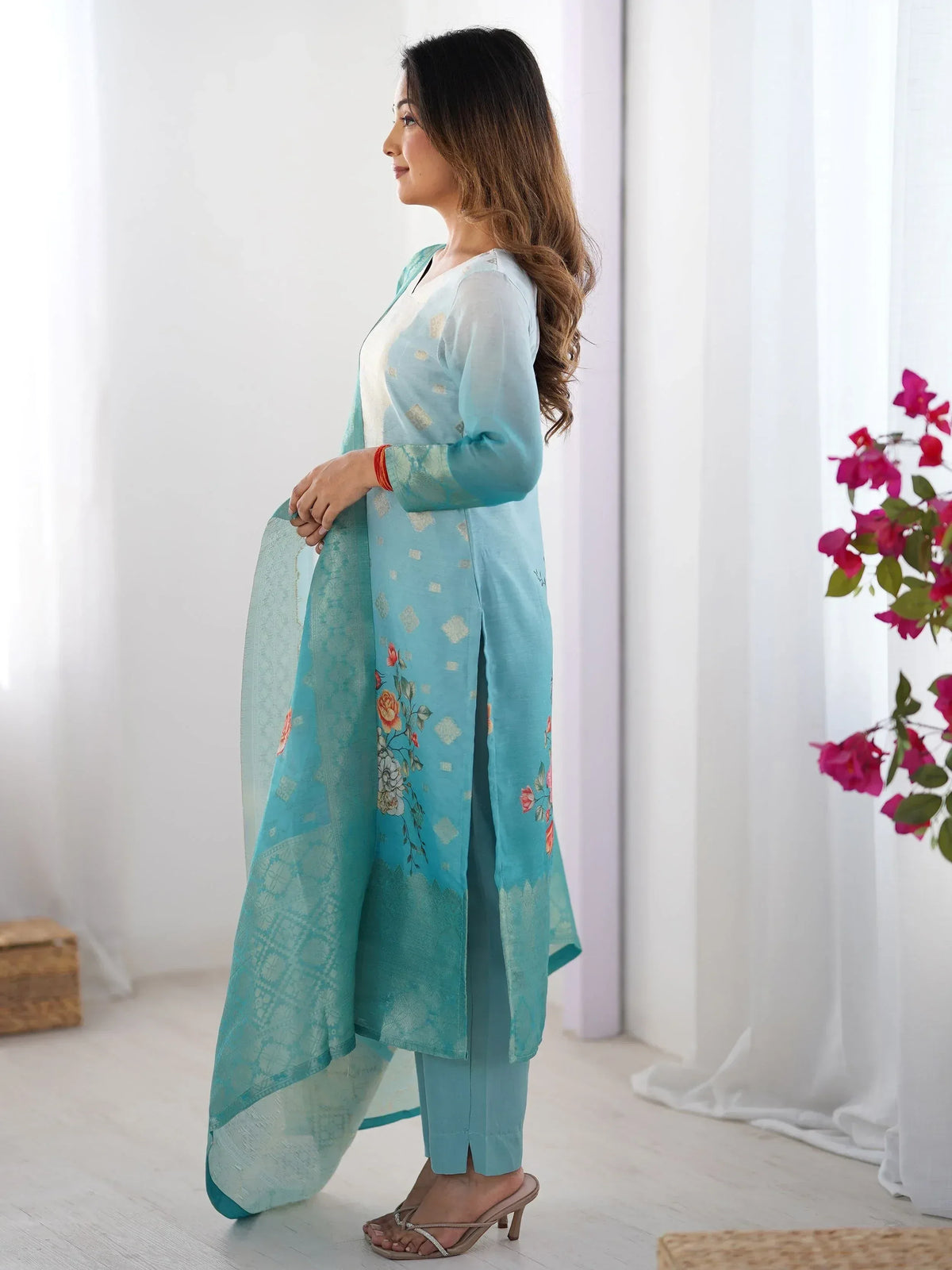 Woman in light blue floral printed salwar kameez with matching dupatta, ethnic Indian wear