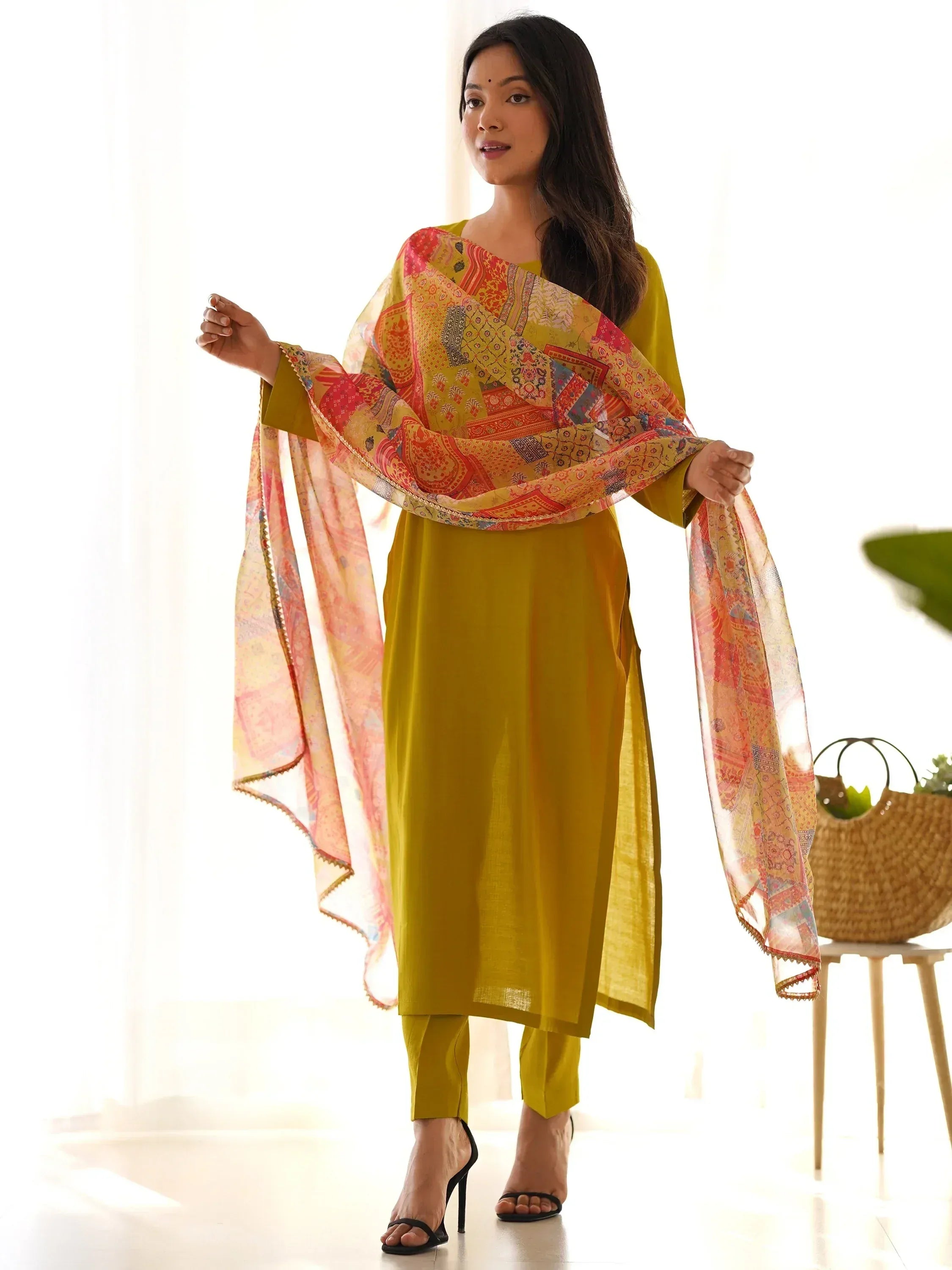 Woman in yellow salwar kameez with colorful printed dupatta, Indian ethnic wear