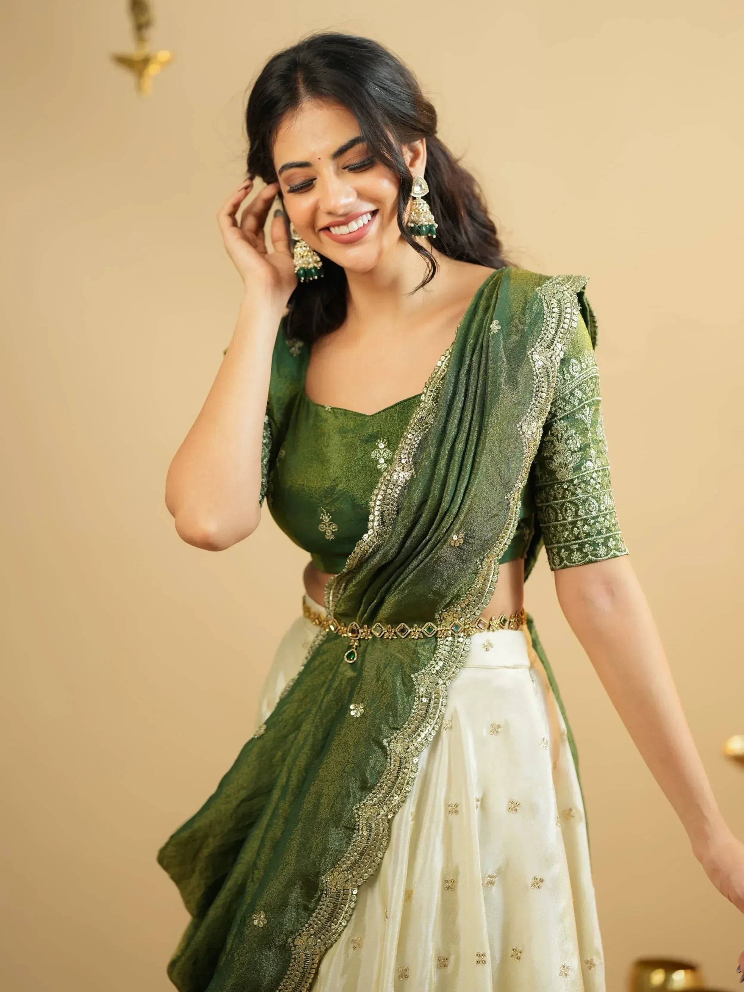 Green and cream designer lehenga choli with gold embroidery and matching jewelry for Indian ethnic wear