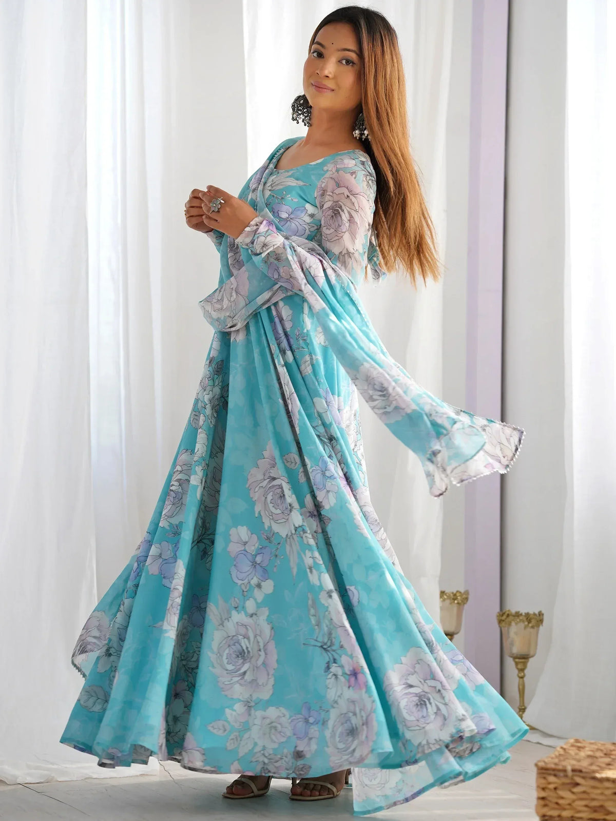 Turquoise floral print ethnic gown with flared sleeves, perfect for Indian occasions and parties.