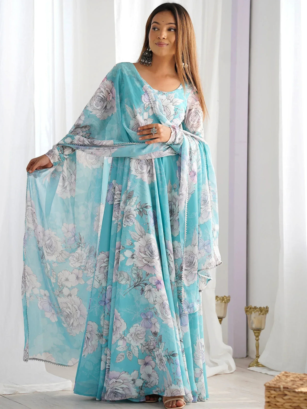 Turquoise floral print ethnic gown with cape sleeves, perfect for Indian occasions and festive wear.