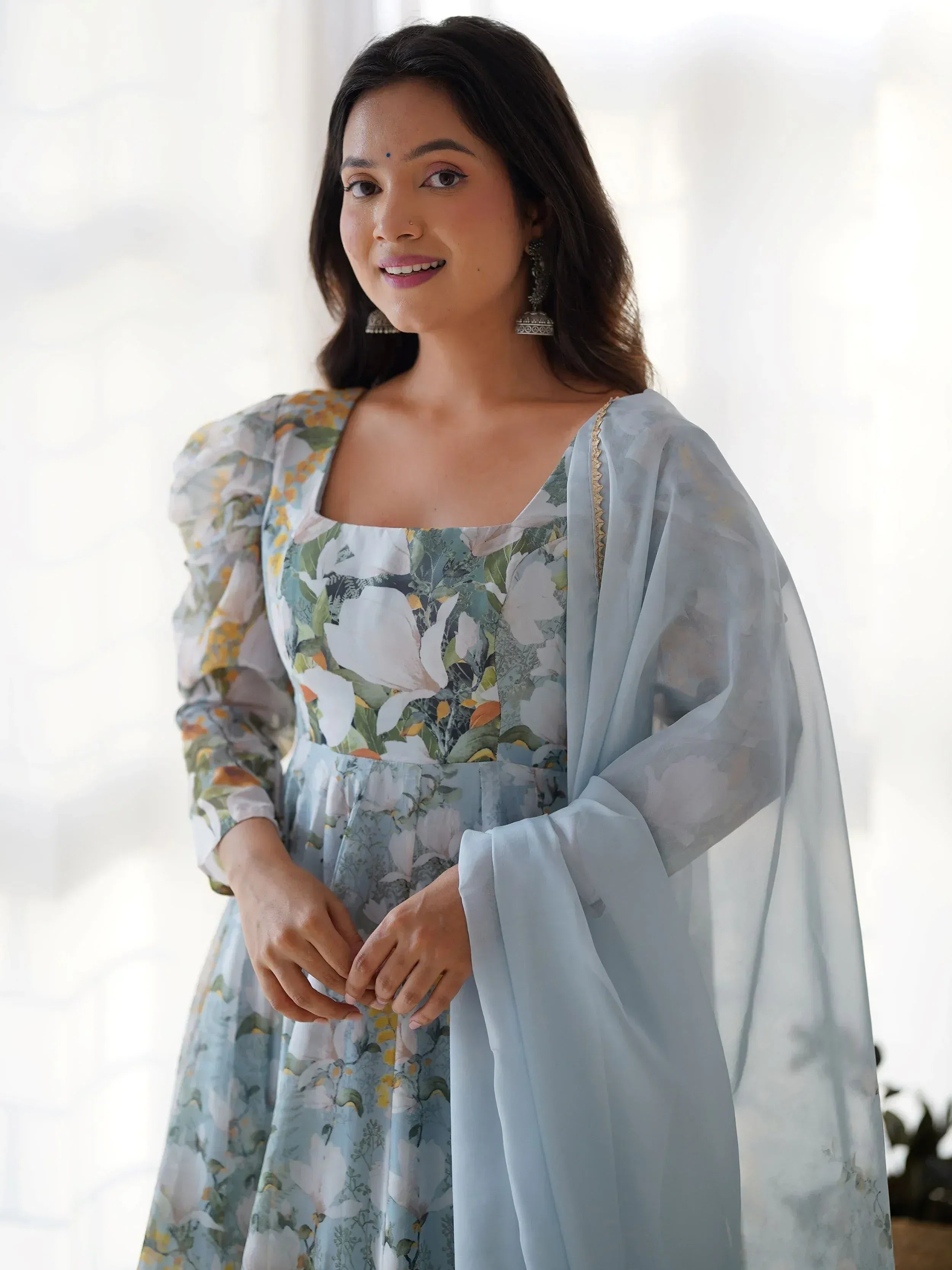 Floral print ethnic gown with puff sleeves and light blue dupatta, perfect for Indian occasions