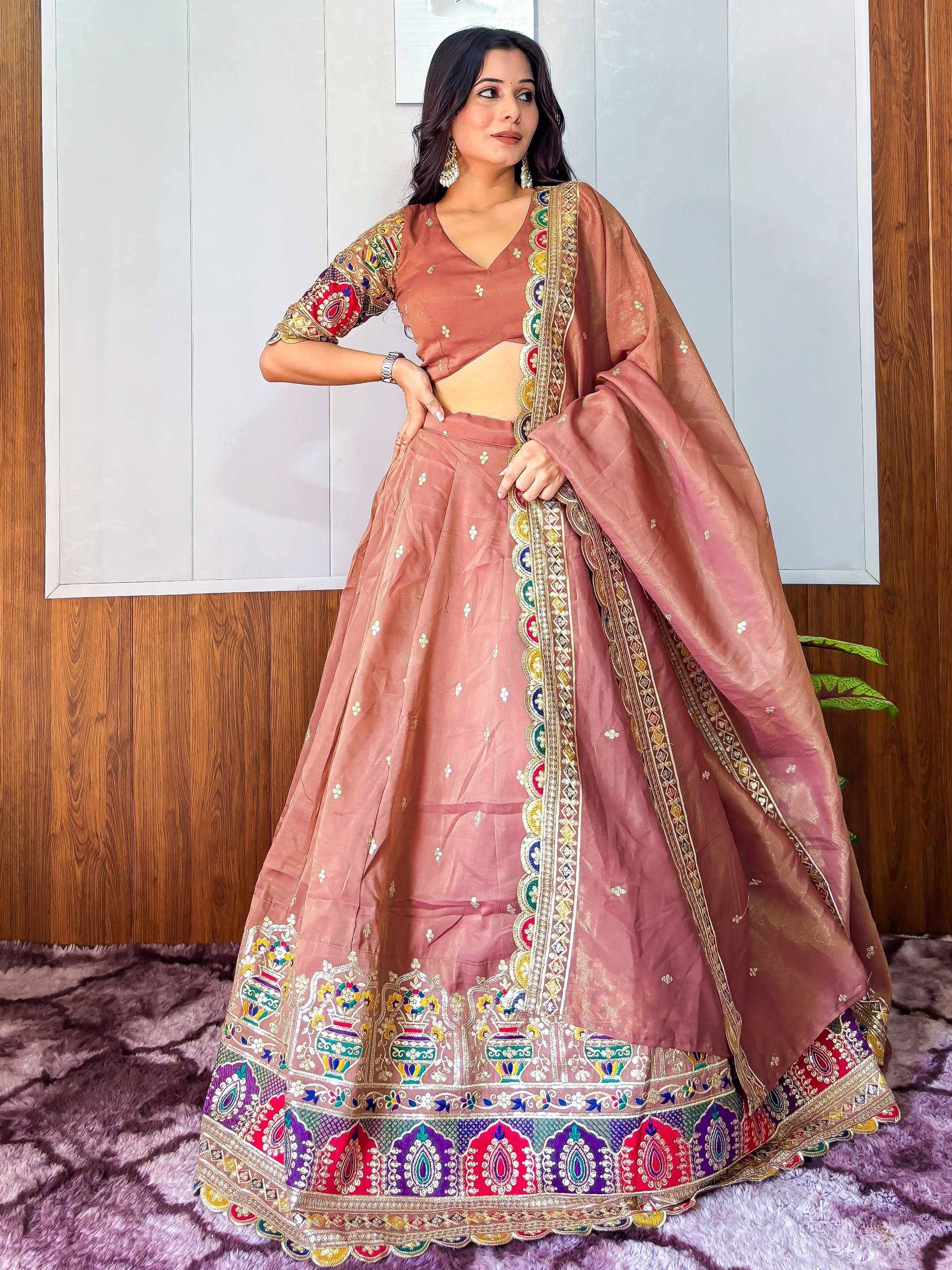 Dusty pink designer lehenga choli with colorful embroidery and mirror work, perfect for Indian ethnic wear