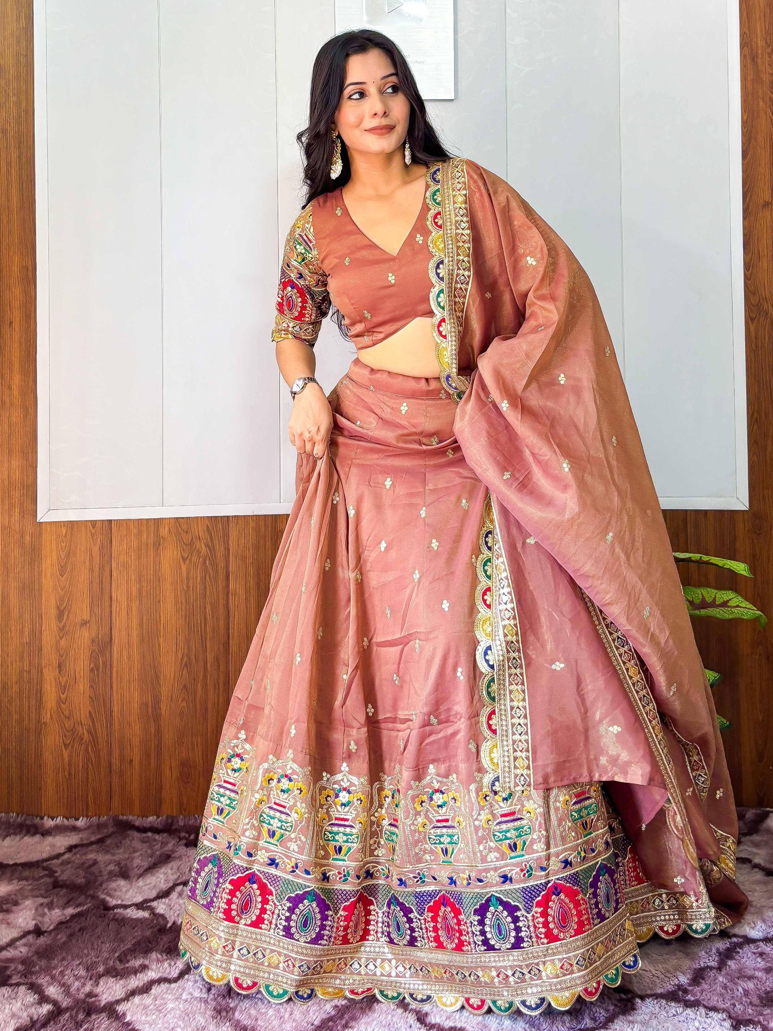 Dusty pink embroidered lehenga choli with colorful border, perfect for Indian ethnic wear occasions