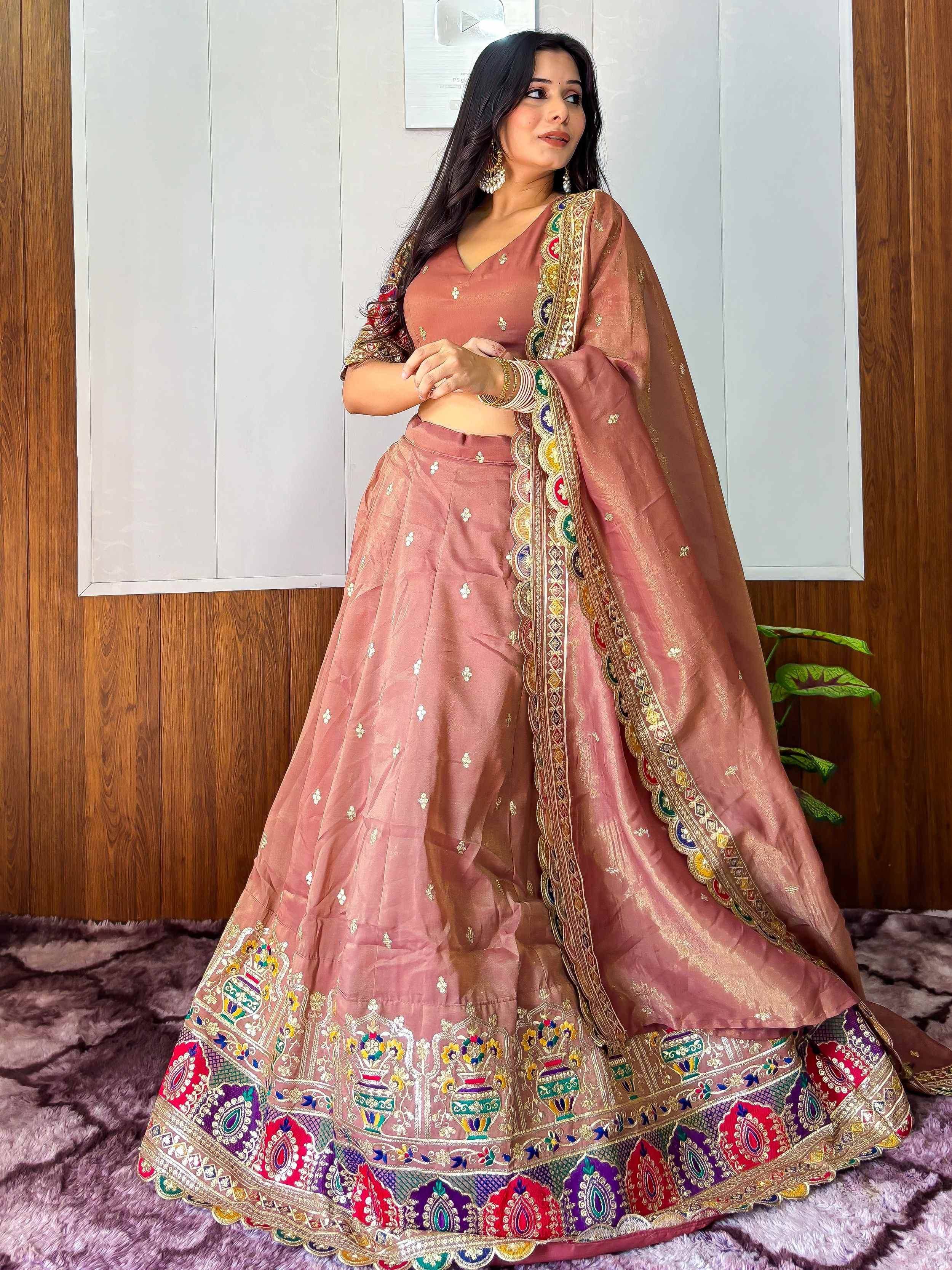 Dusty pink embroidered lehenga choli with colorful border, perfect for Indian ethnic wear occasions