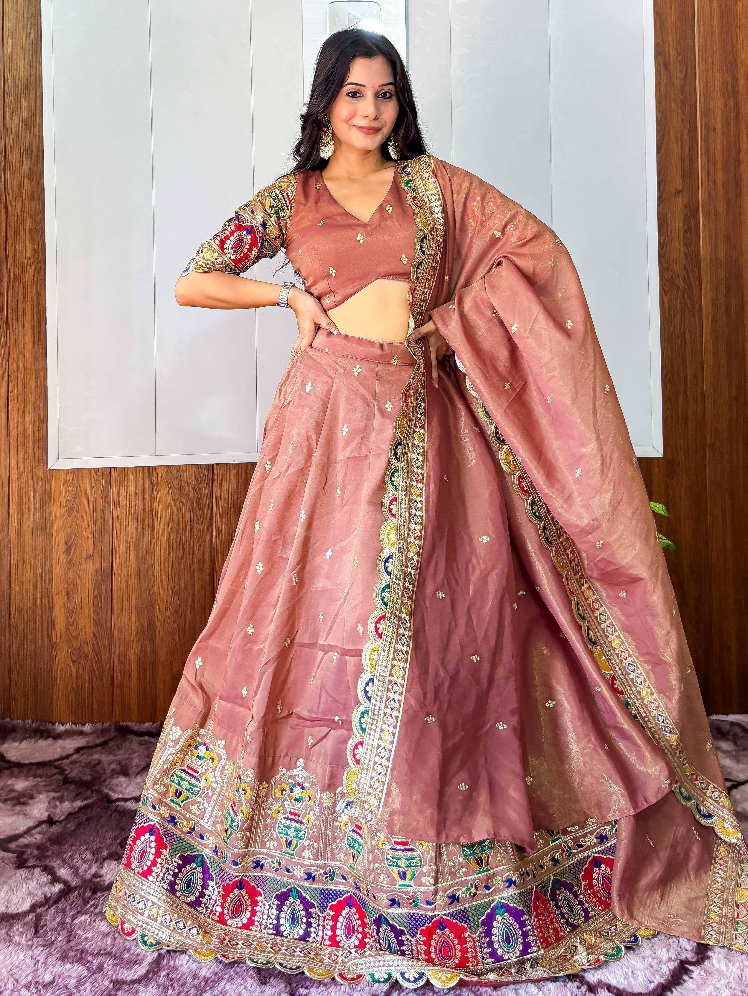 Dusty pink embroidered lehenga choli with colorful border, perfect for Indian ethnic wear and festive occasions.