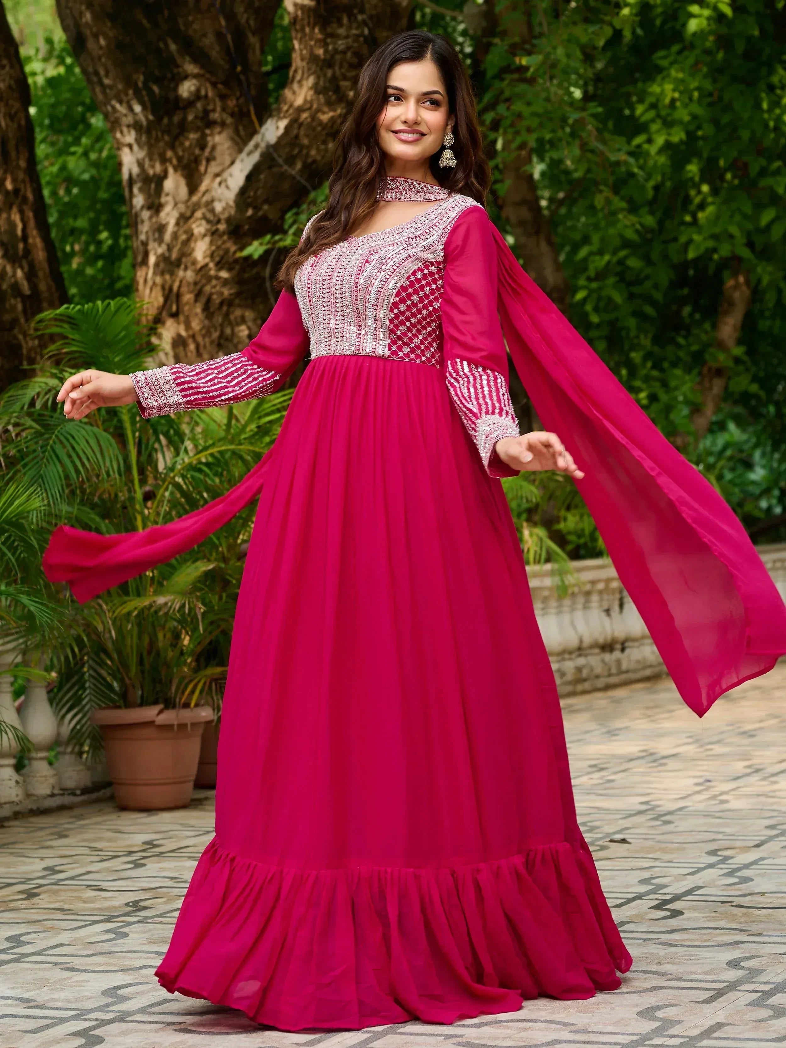 Fuchsia ethnic gown with silver embroidery, flared sleeves, and ruffled hem for Indian occasions