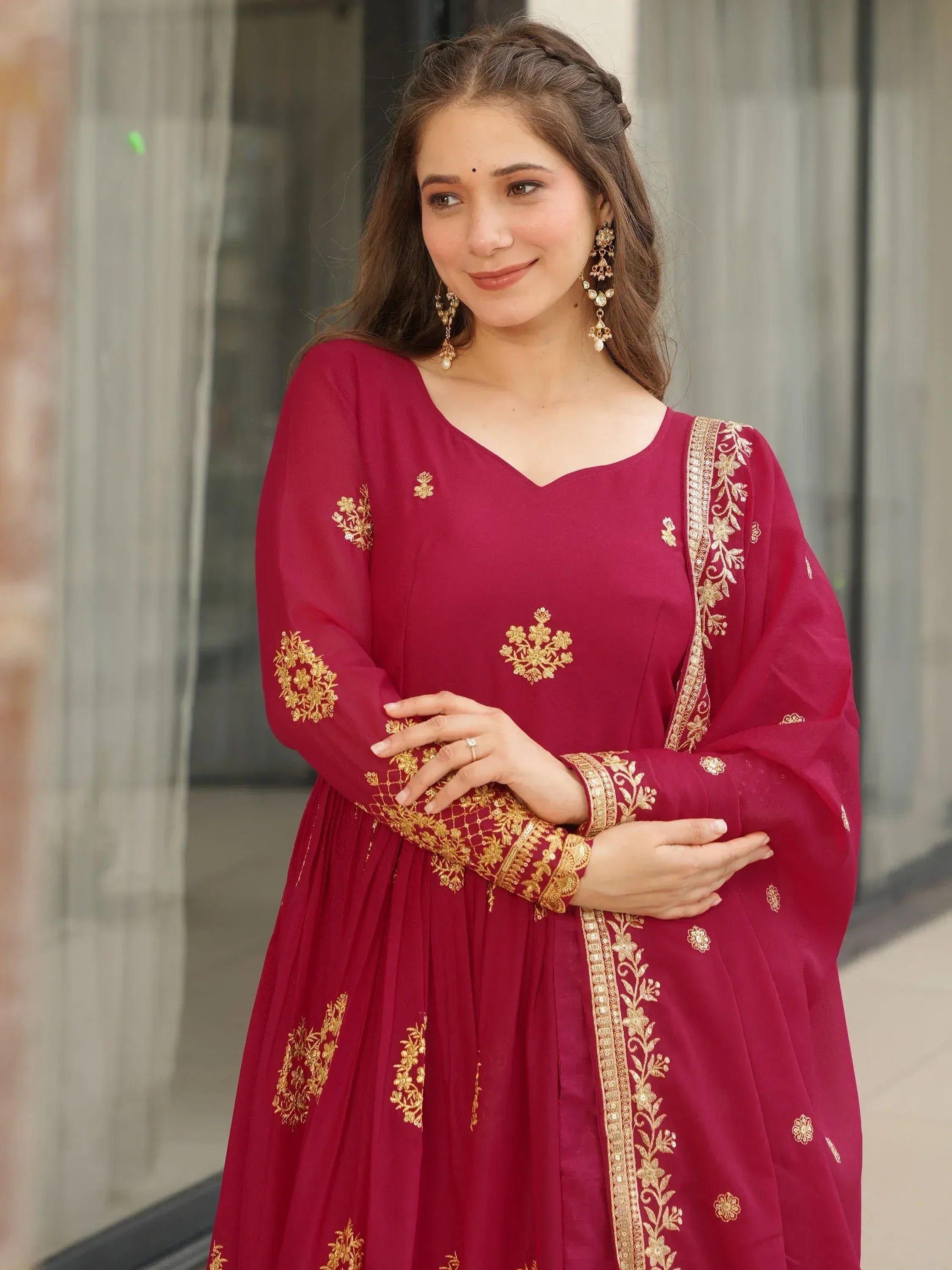 Maroon ethnic gown with gold embroidery, perfect for Indian occasions and festive wear.