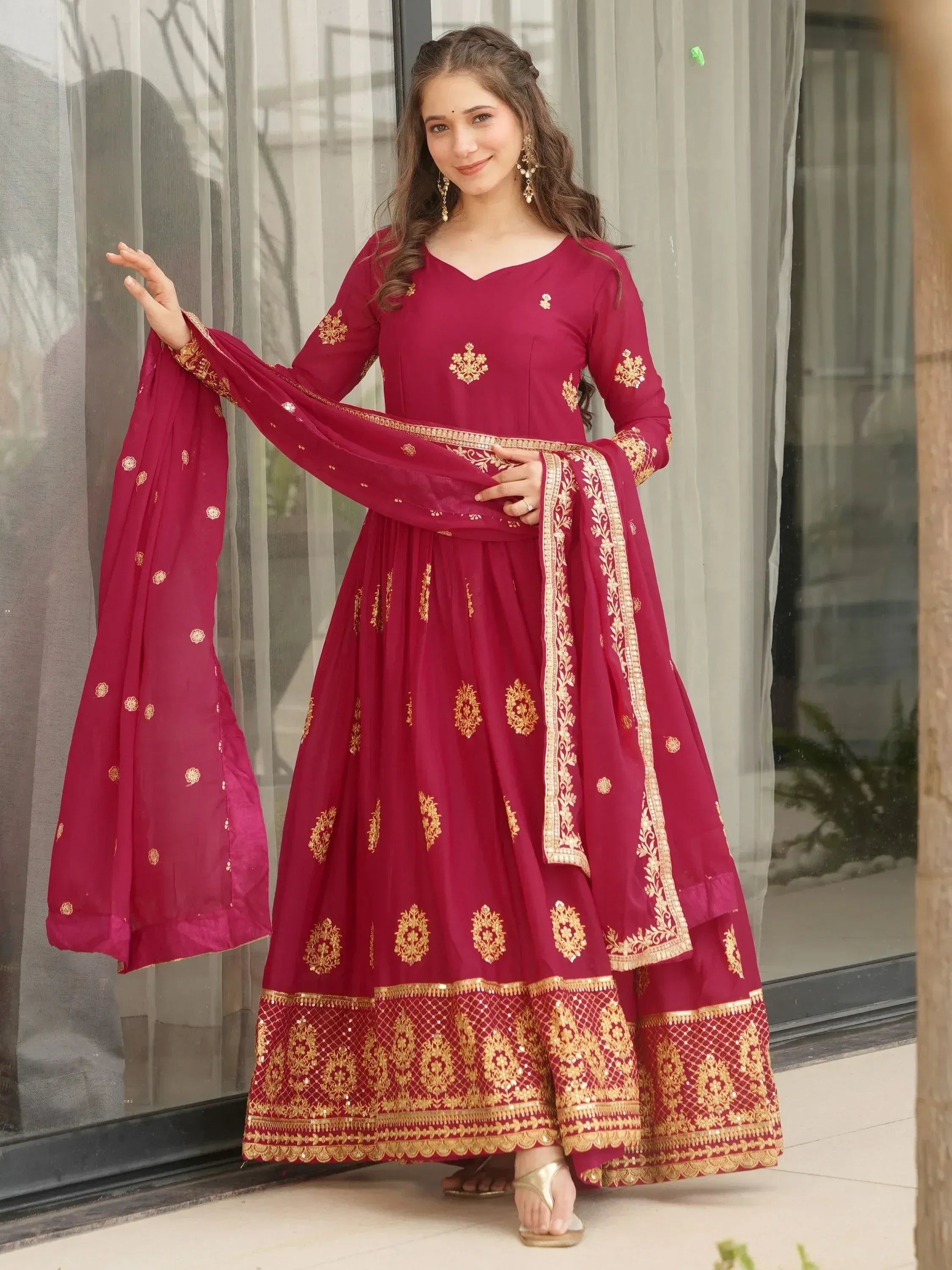 Maroon Indian ethnic anarkali suit with gold embroidery, perfect for festive occasions and weddings.