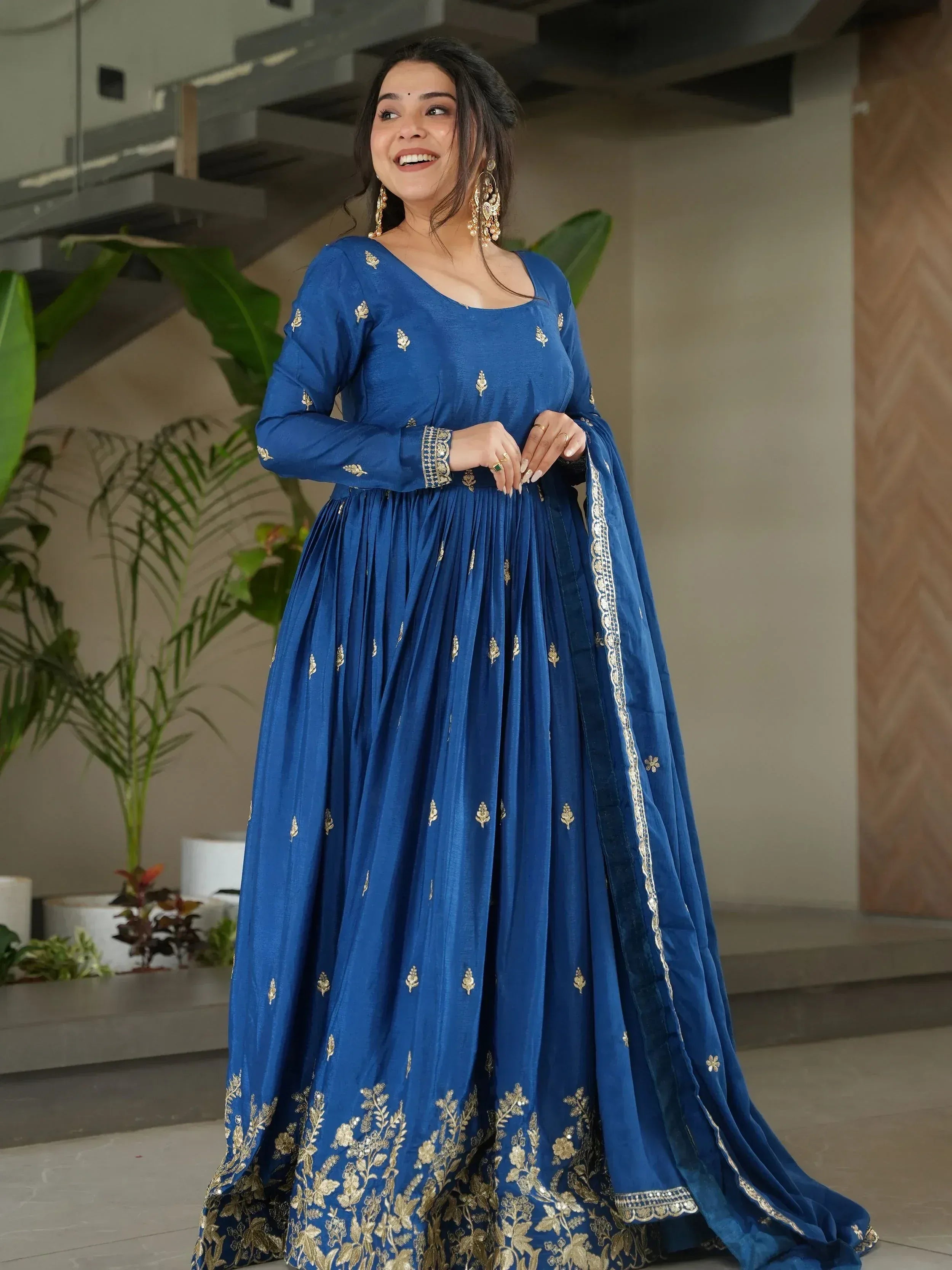 Blue ethnic anarkali gown with gold embroidery, perfect for Indian weddings and festive occasions