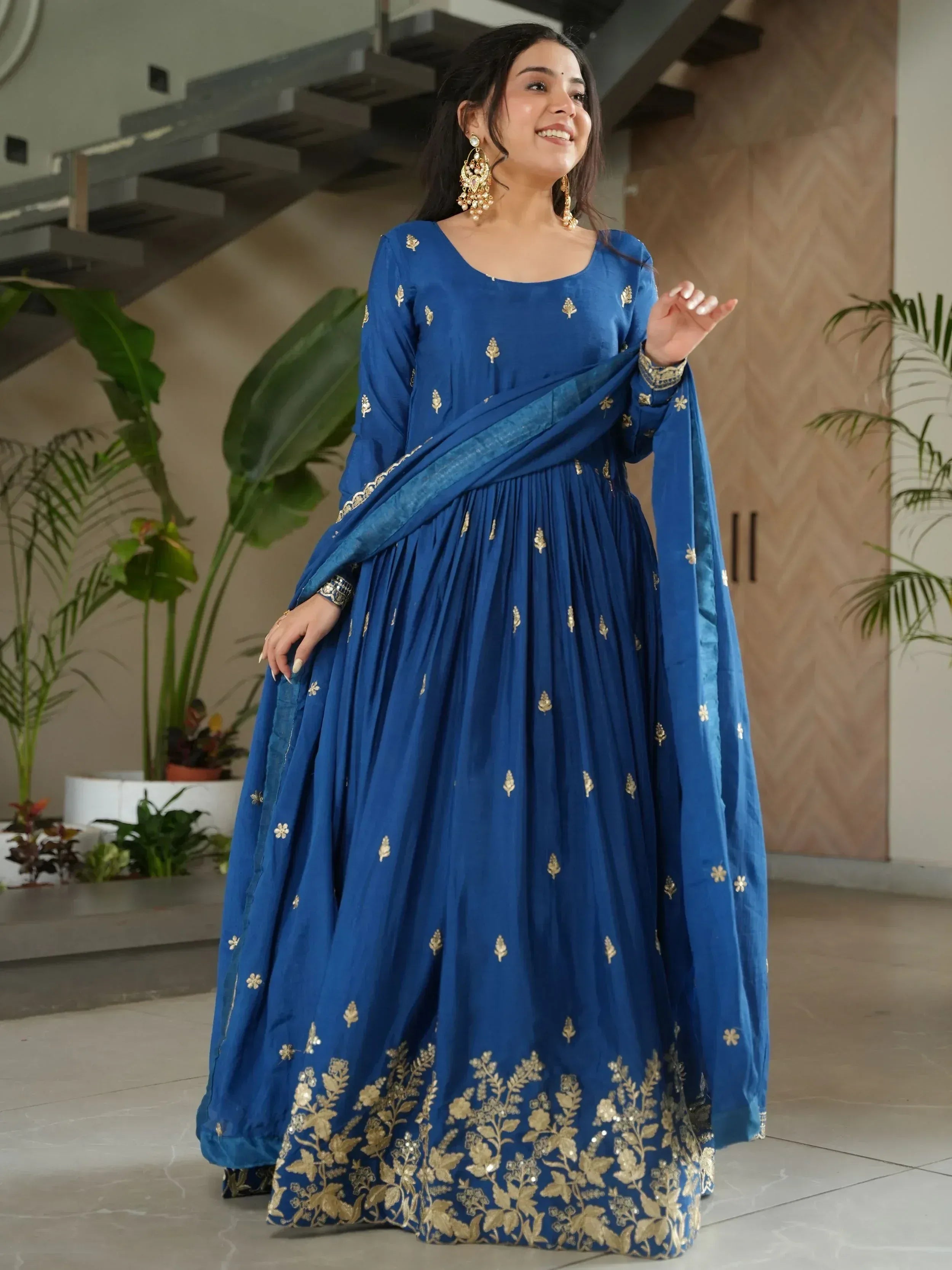 Blue ethnic anarkali with gold embroidery, perfect for Indian occasions and festive wear.
