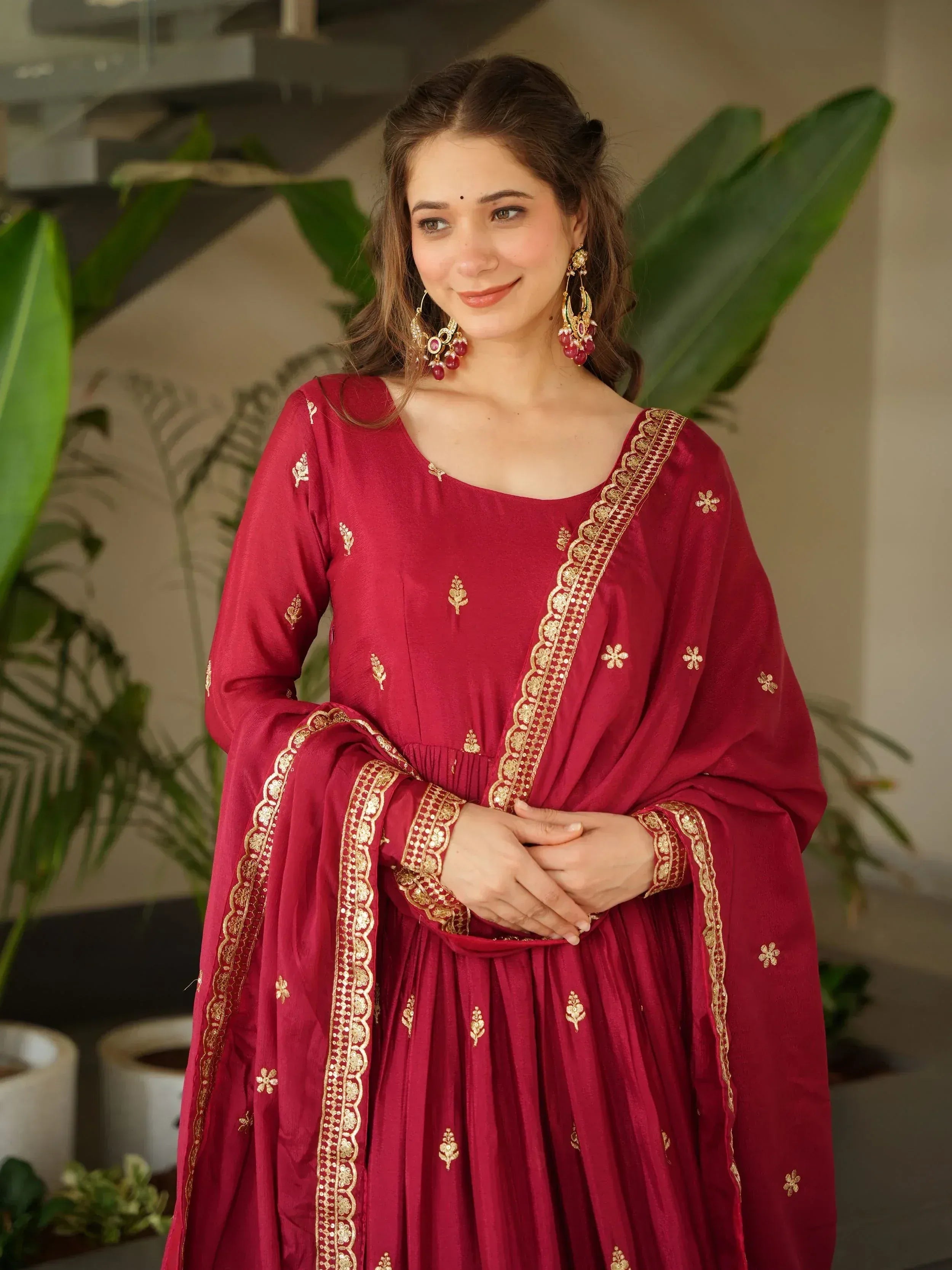 Maroon ethnic gown with gold embroidery, perfect for Indian festive occasions and weddings