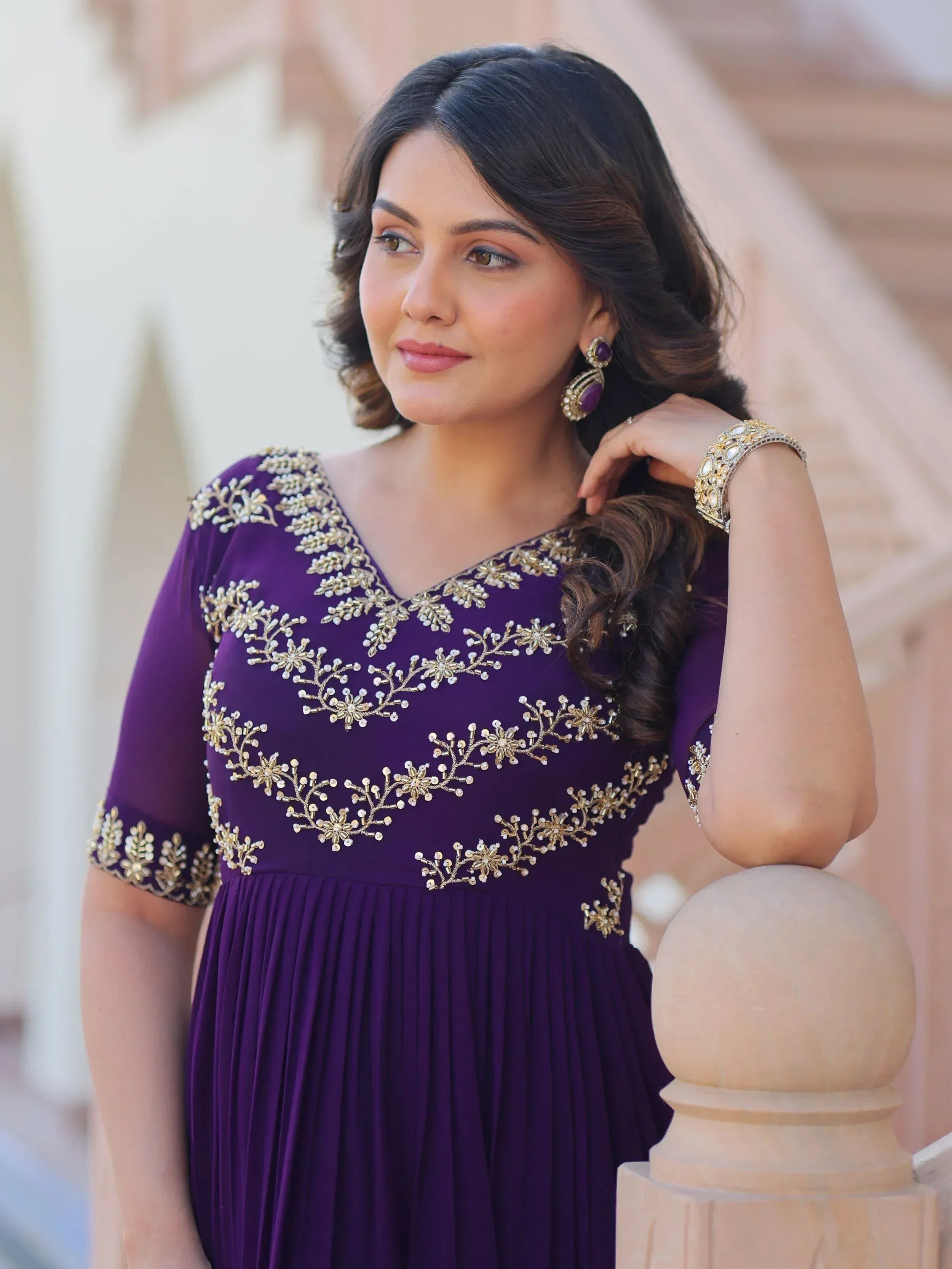 Purple ethnic gown with gold floral embroidery, perfect for Indian weddings or festive occasions.