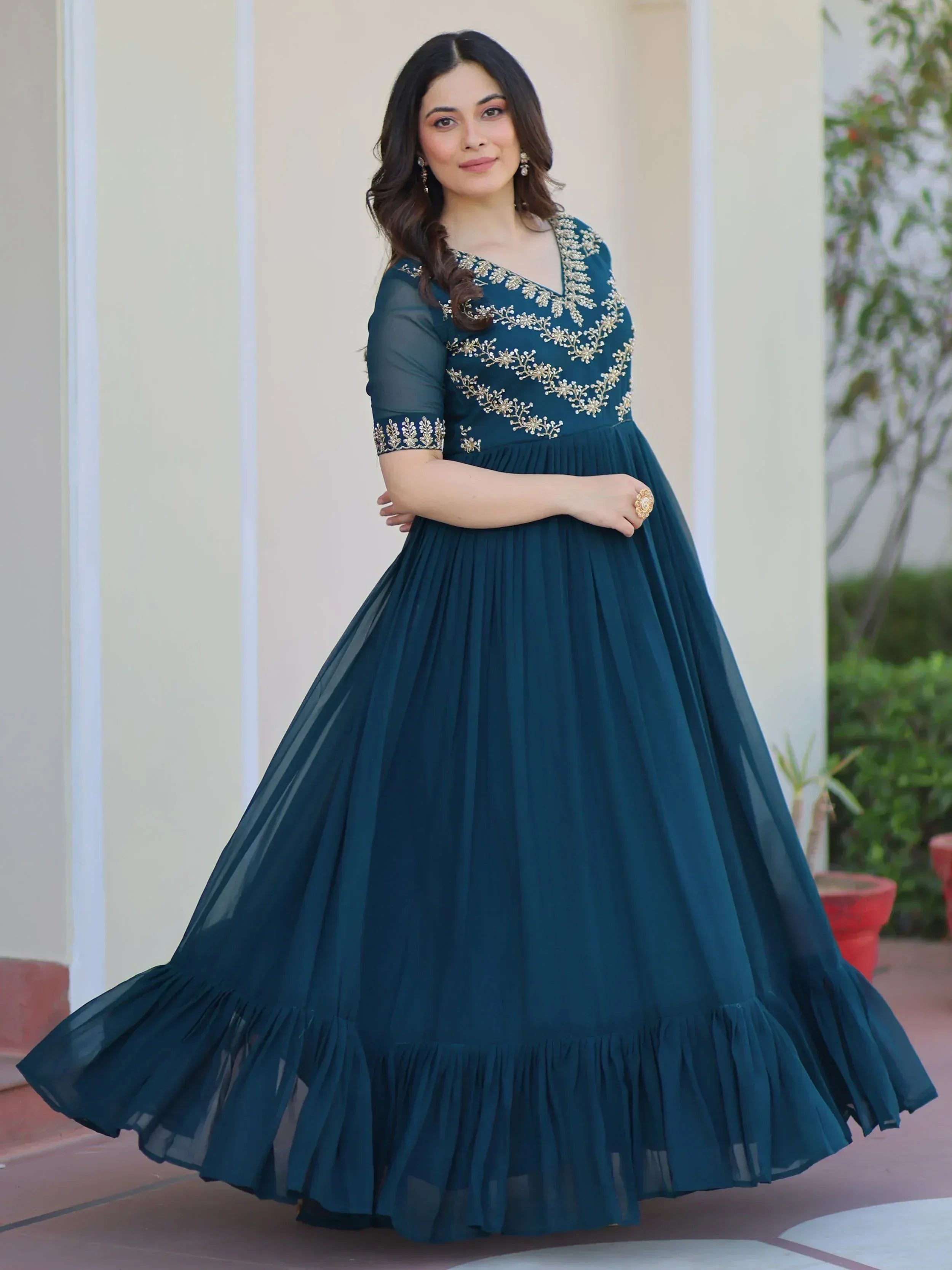 Teal ethnic gown with gold embroidery, pleated skirt, and sheer sleeves for women