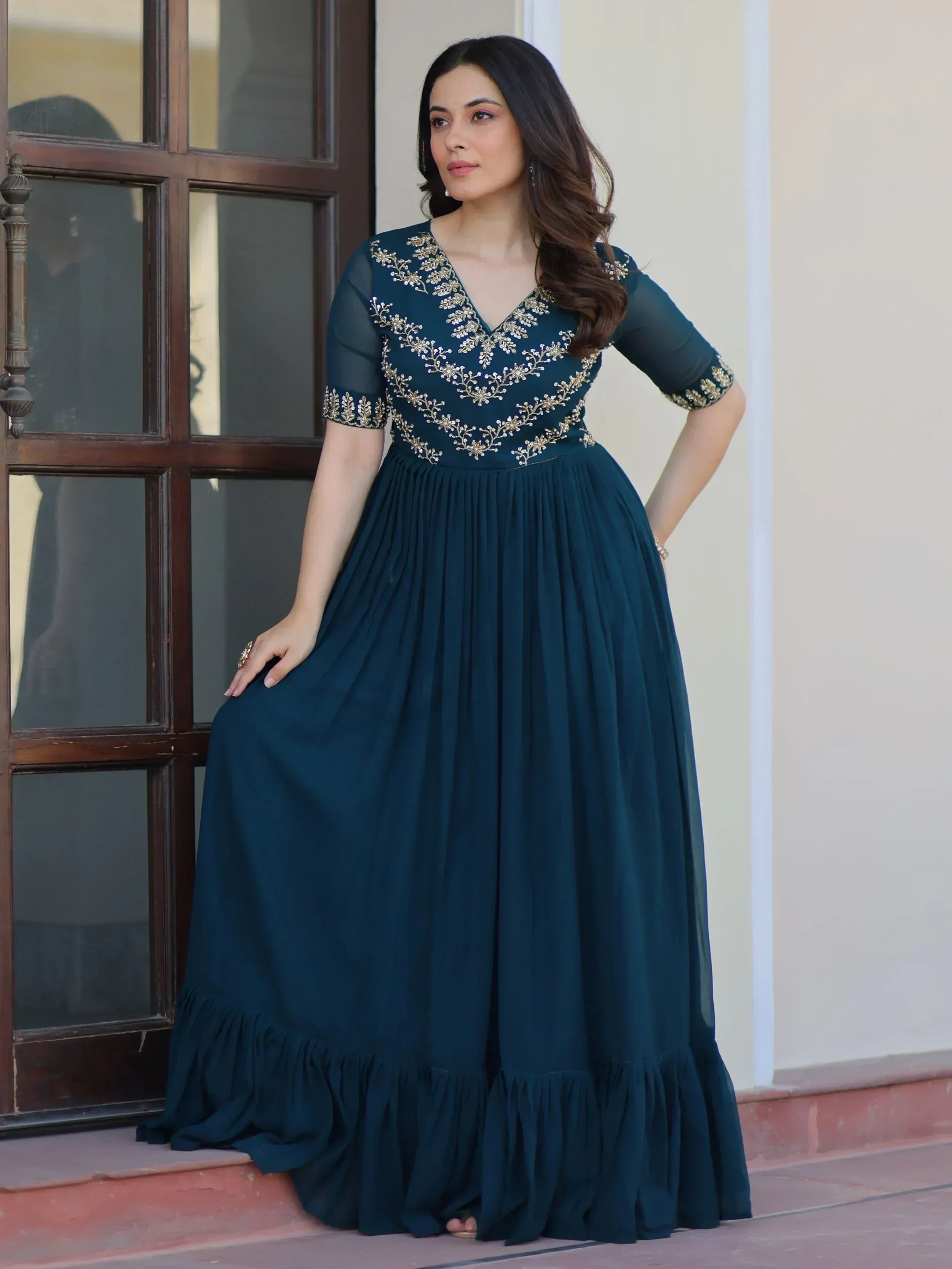 Elegant teal ethnic gown with gold embroidery, perfect for Indian occasions and festive events.