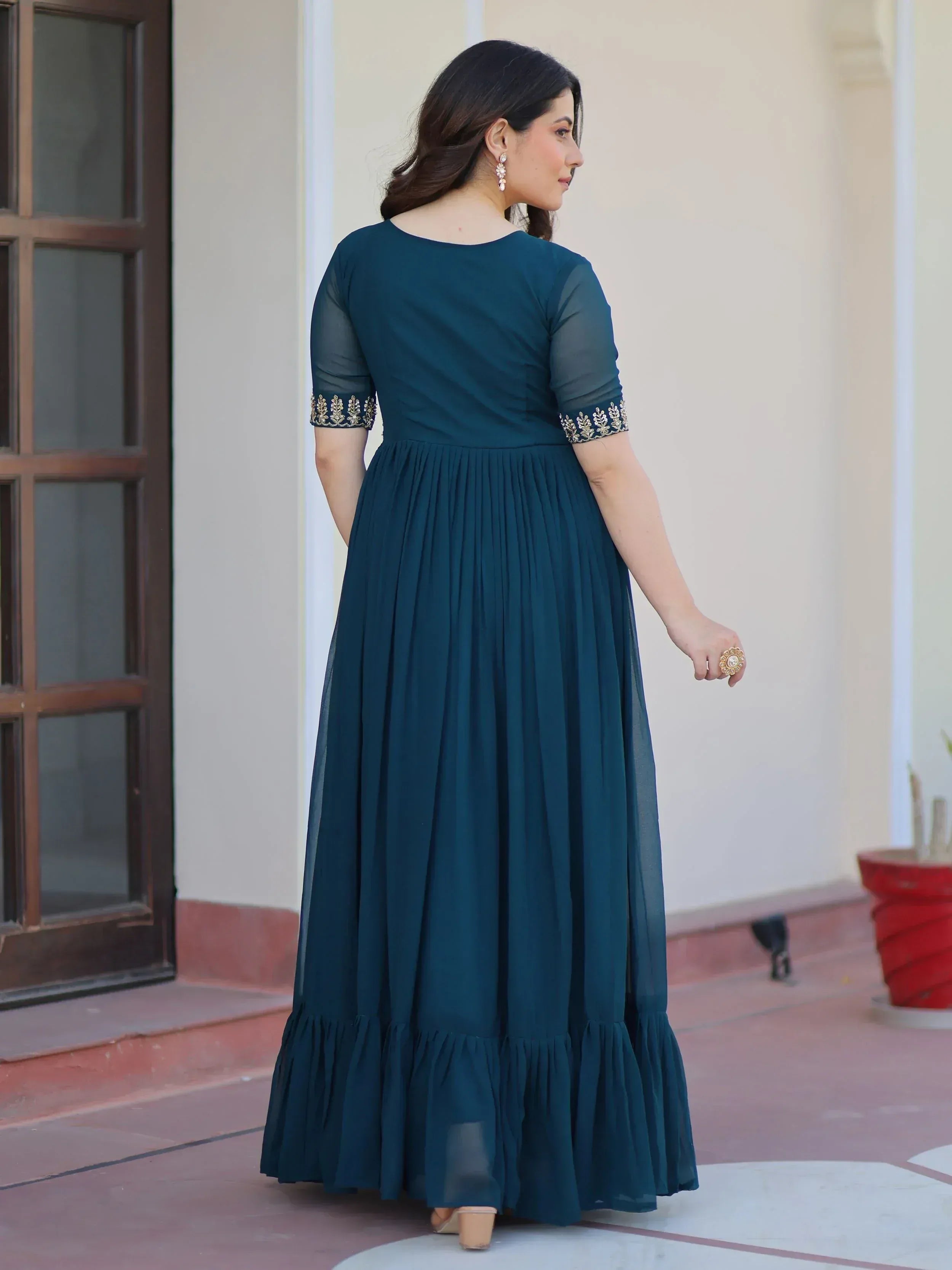 Teal ethnic gown with gold embroidery, sheer sleeves, and pleated skirt for women