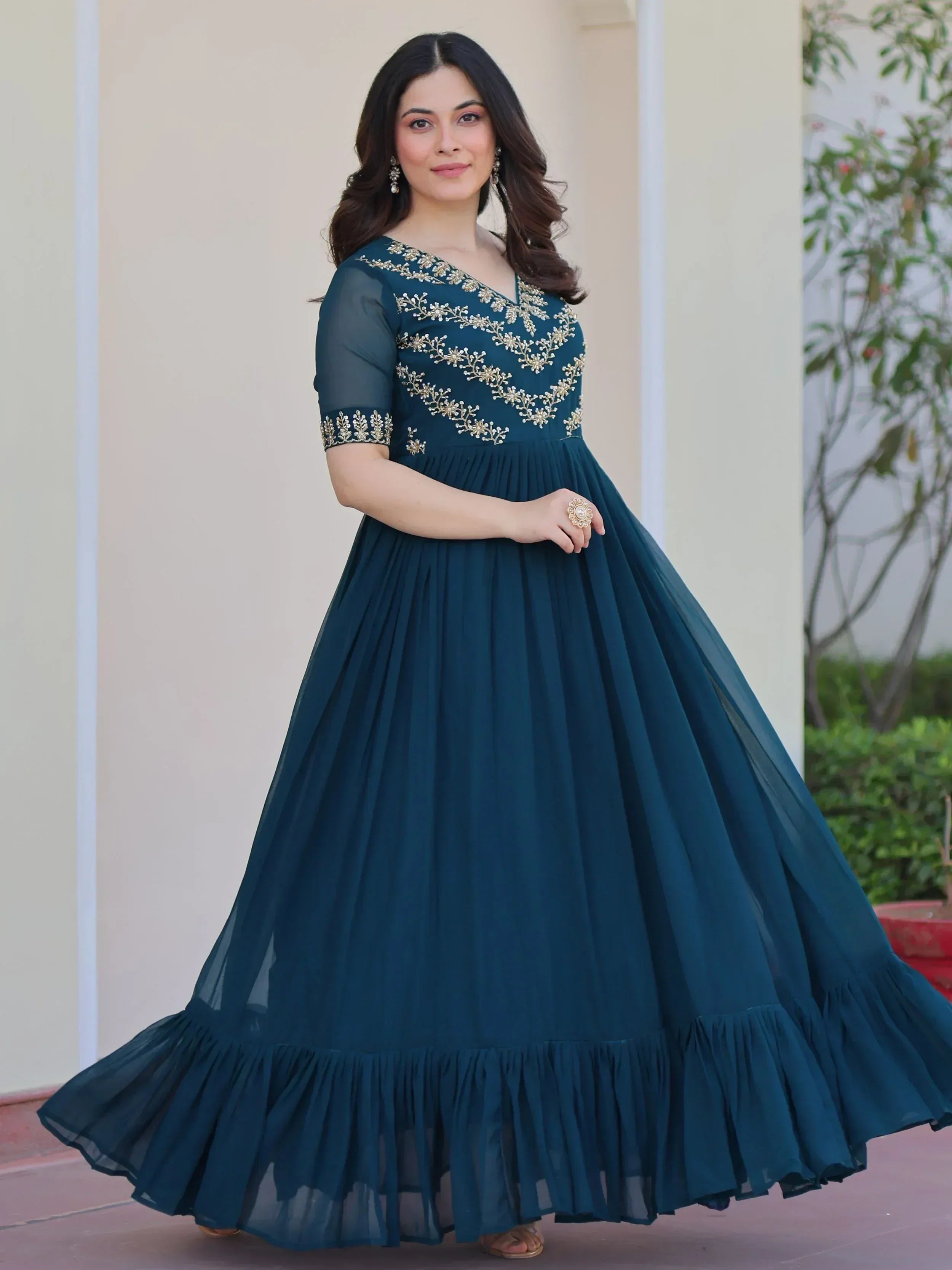 Teal ethnic gown with gold embroidery, perfect for Indian occasions and festive wear.